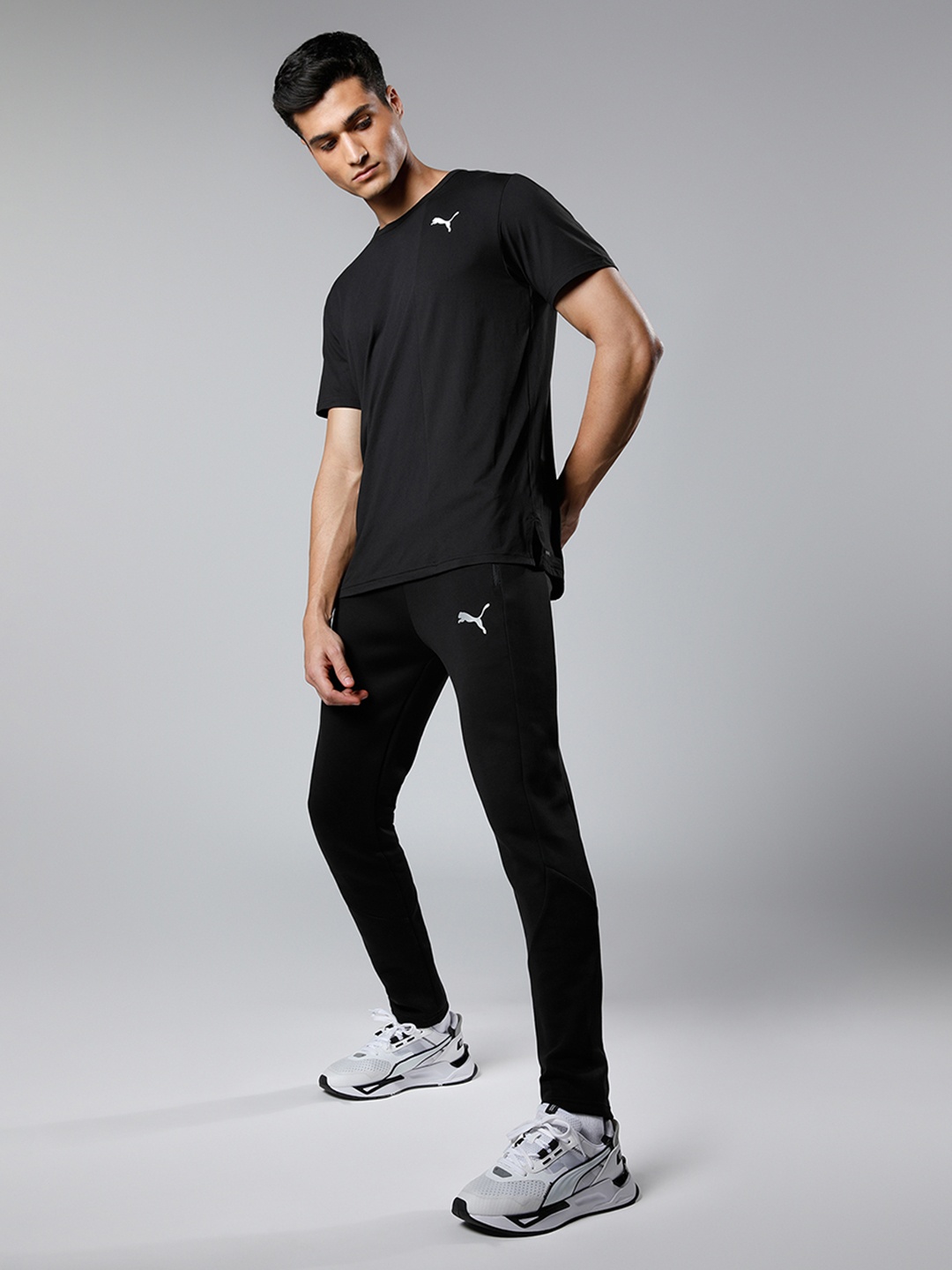 

Puma Men Black Solid Evostripe Mid Rise Elasticated Dry Cell Tapered Sustainable Track Pants