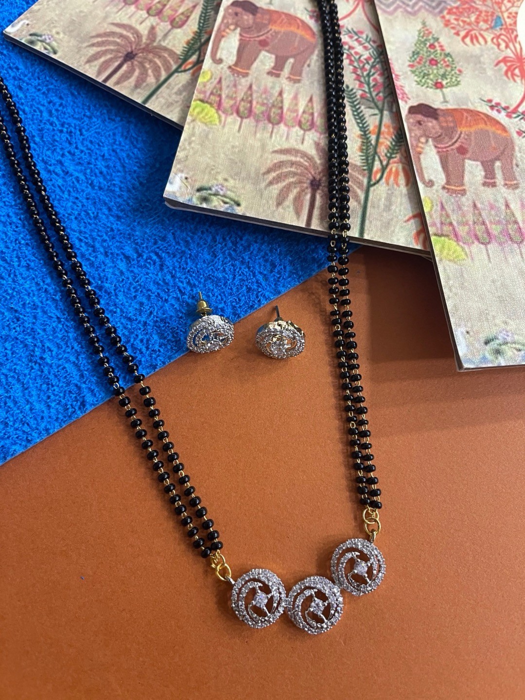 

Digital Dress Room Gold-Plated White & Black Stone-Studded Beaded Mangalsutra With Earrings
