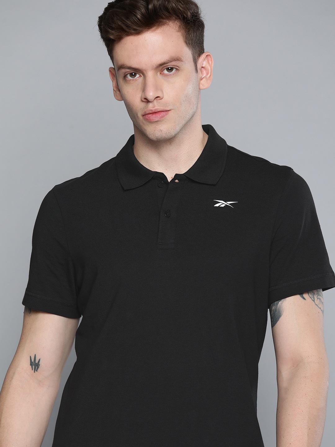 

Reebok Men Black Solid Polo Collar Pure Cotton T-shirt