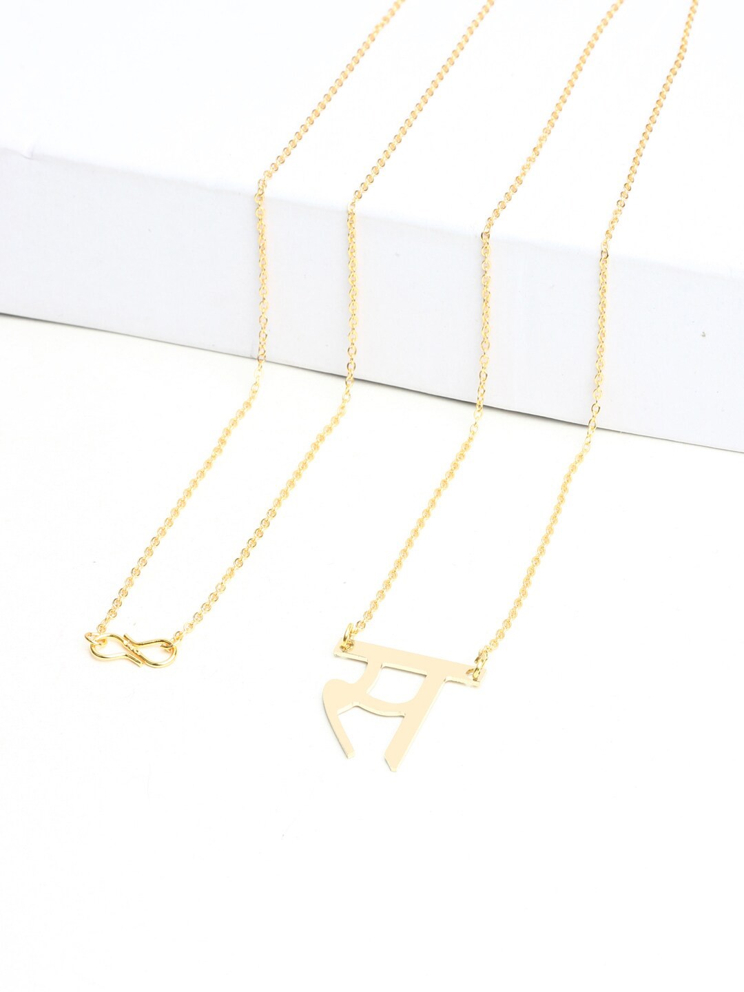 

Goldnera Brass-Plated Hindi Akshar Letter Trending Charm Pendant With Chain, Gold