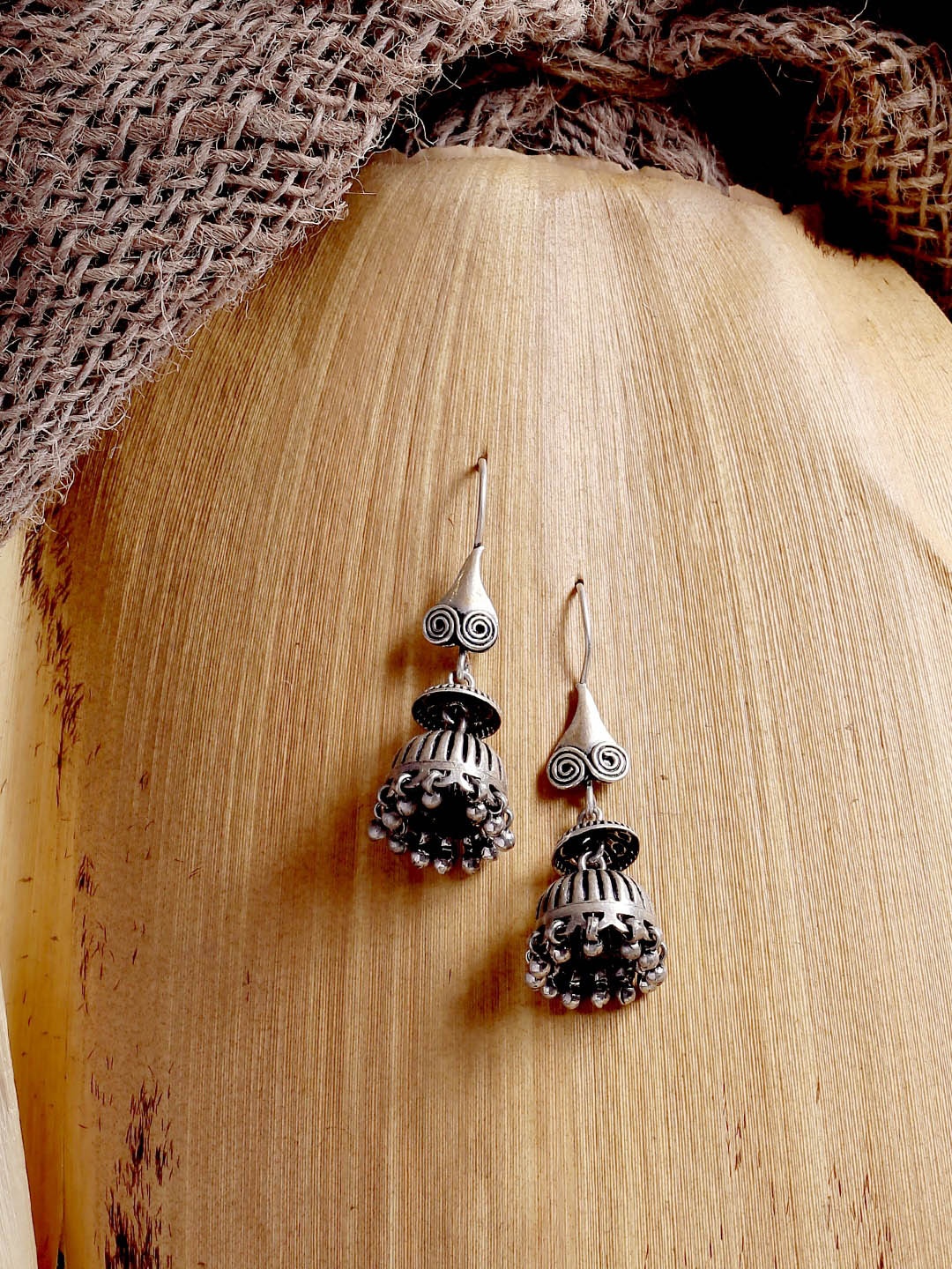 

ADORN by Nikita Ladiwala Silver-Toned Dome Shaped Jhumkas Earrings