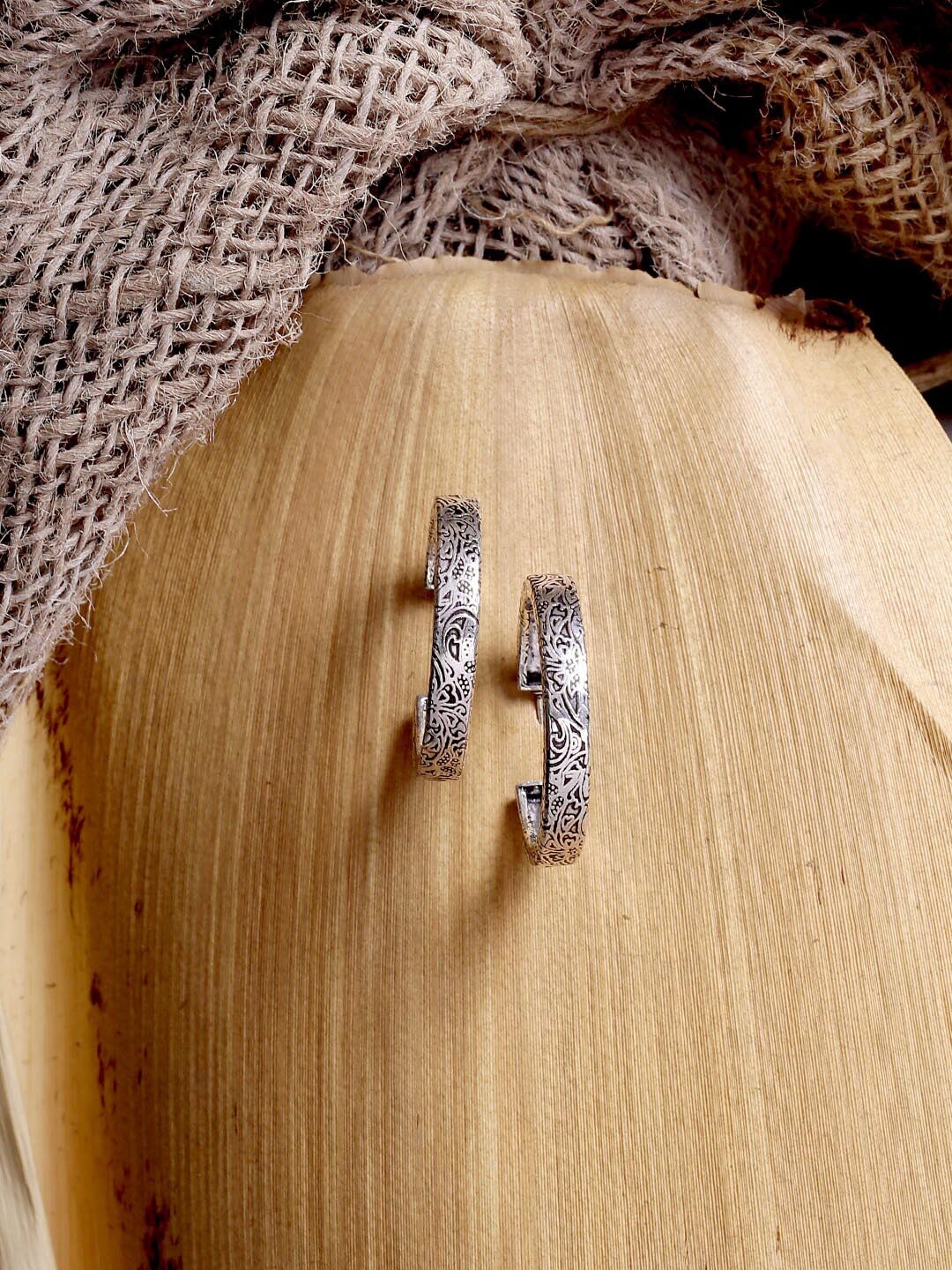 

ADORN by Nikita Ladiwala Silver-Toned Circular Half Hoop Earrings