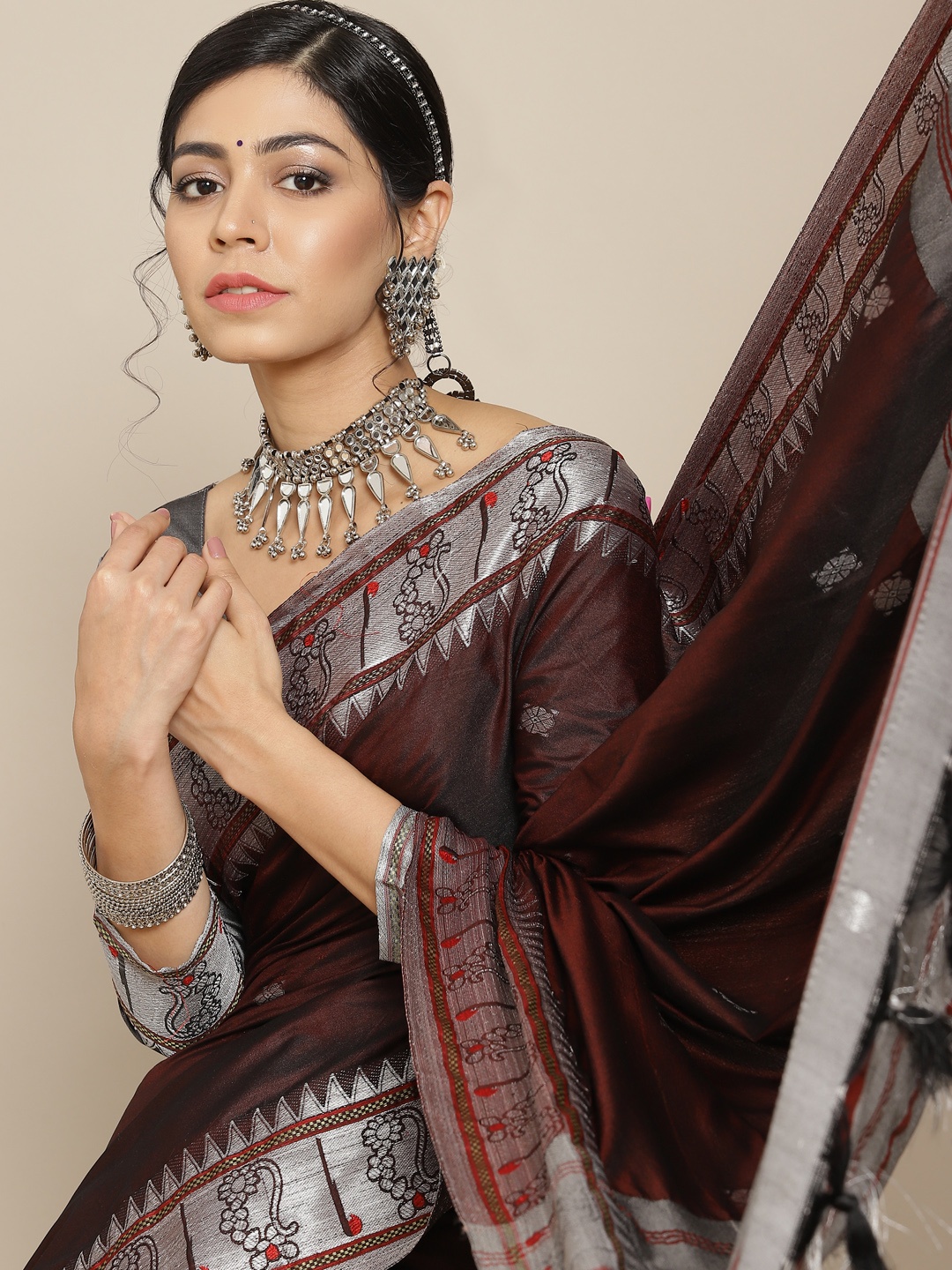 

Mitera Brown & Silver-Toned Ethnic Motifs Zari Silk Cotton Banarasi Saree