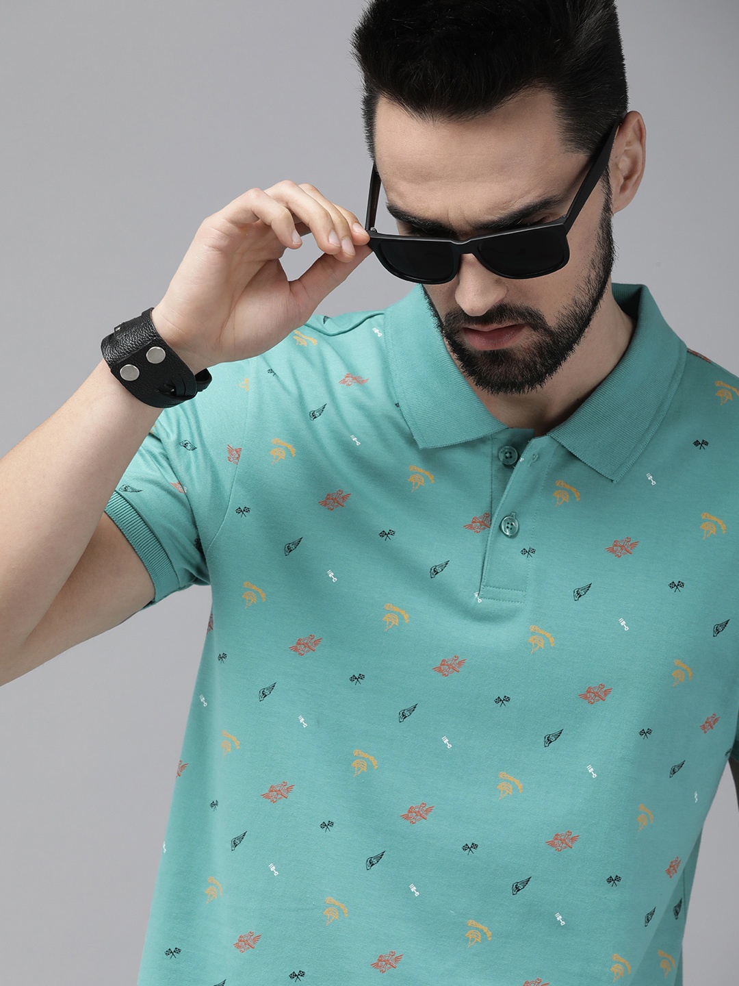 

The Roadster Lifestyle Co Men Teal Green & Black Printed Polo Collar Pure Cotton T-shirt