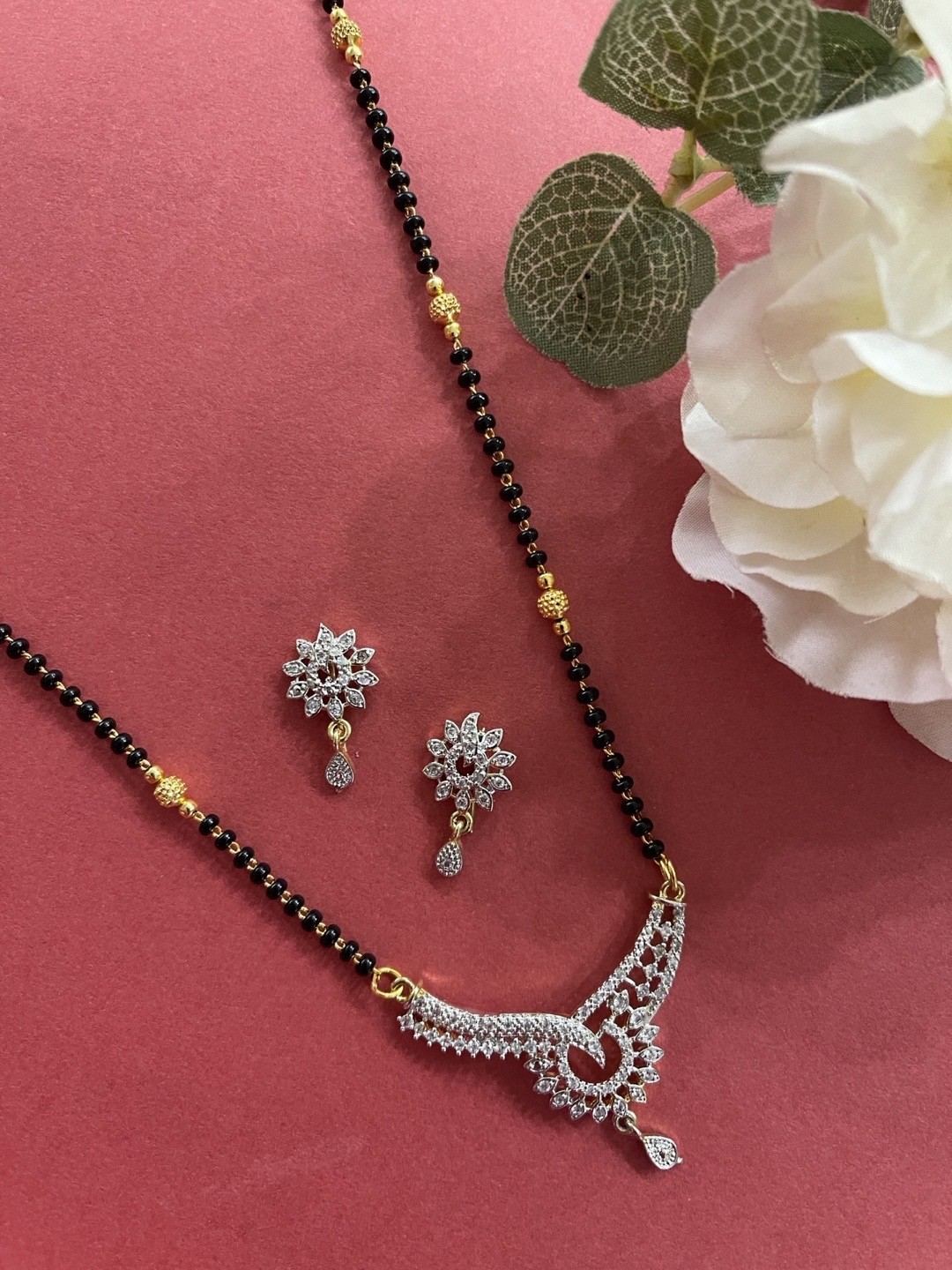 

Digital Dress Room Gold-Plated White AD Studded & Black Beaded Mangalsutra