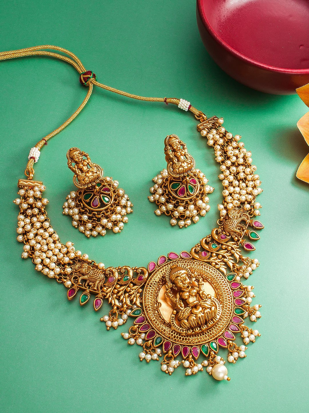 

aadita Gold-Plated Red & Green Stone Studded & Beaded Temple Jewellery Set