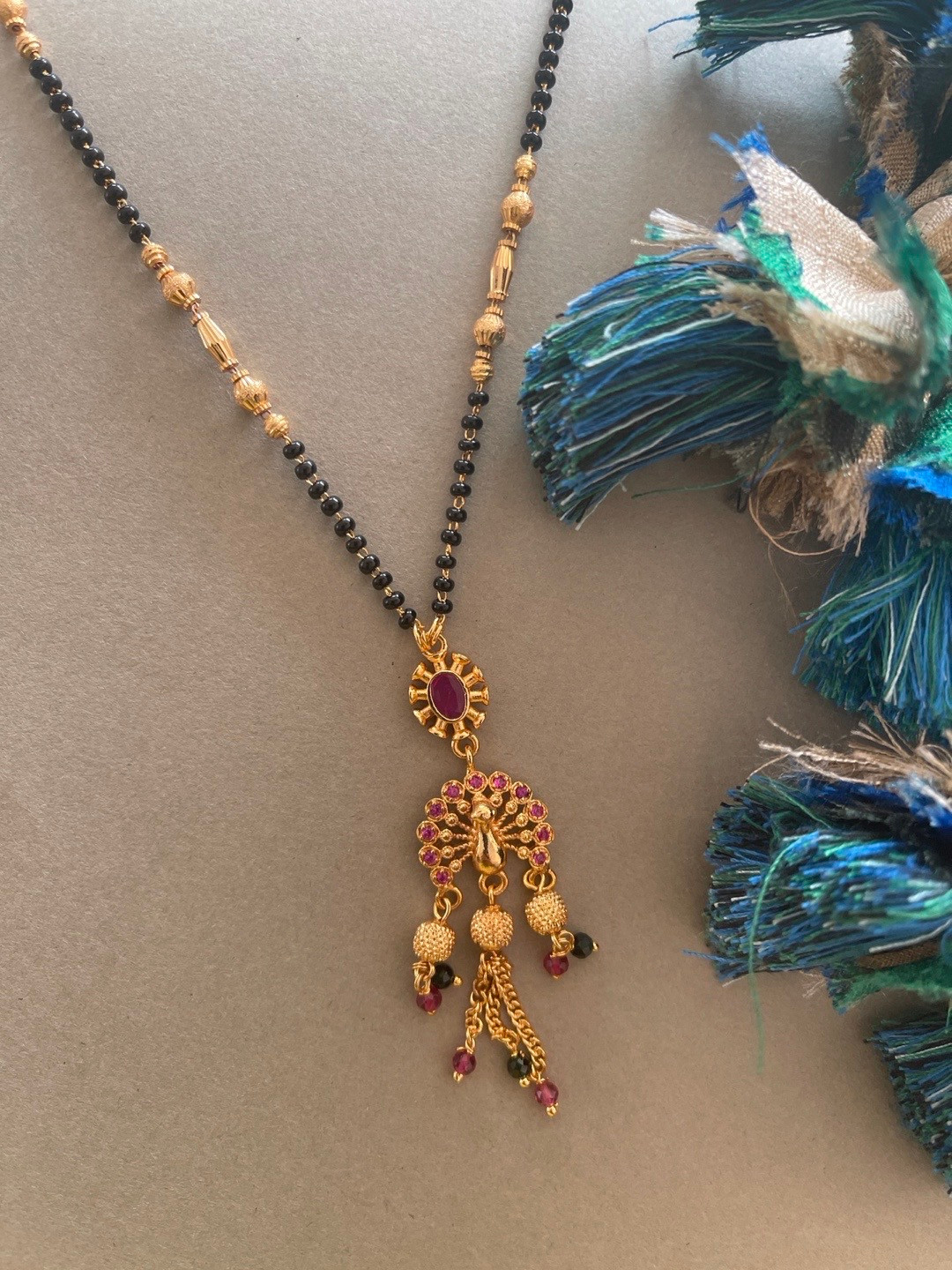 

Digital Dress Room Gold-Plated Pink & Black AD-Studded Peacock Shaped Mangalsutra
