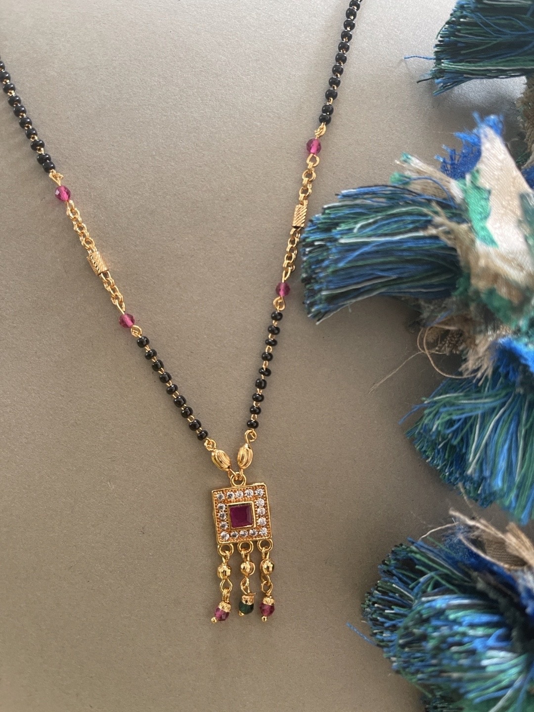 

Digital Dress Room Gold-Plated White & Black AD Stone-Studded Beaded Mangalsutra