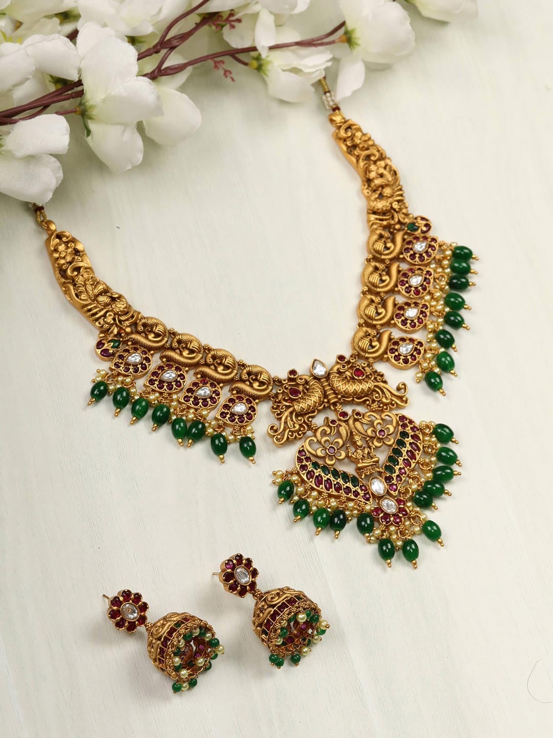 

Priyaasi Gold-Plated & Green Pearls Beads Kundan Stones Peacock Choker Jewellery Set