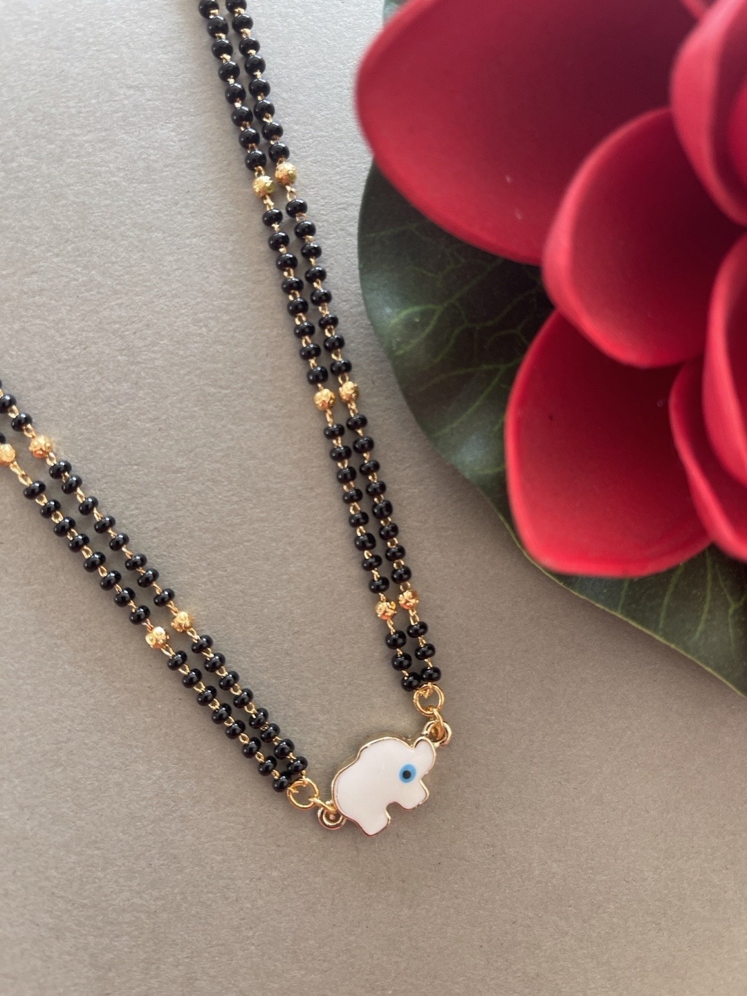 

Digital Dress Room Women Gold-Plated & Black Beaded Elephant Evil Eye Mangalsutra