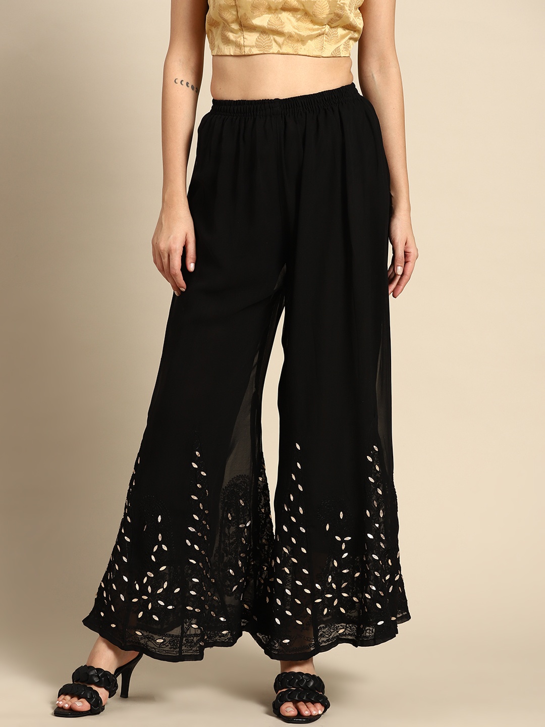 

Saadgi Women Black & Golden Ethnic Motifs Embroidered Flared Ethnic Palazzos