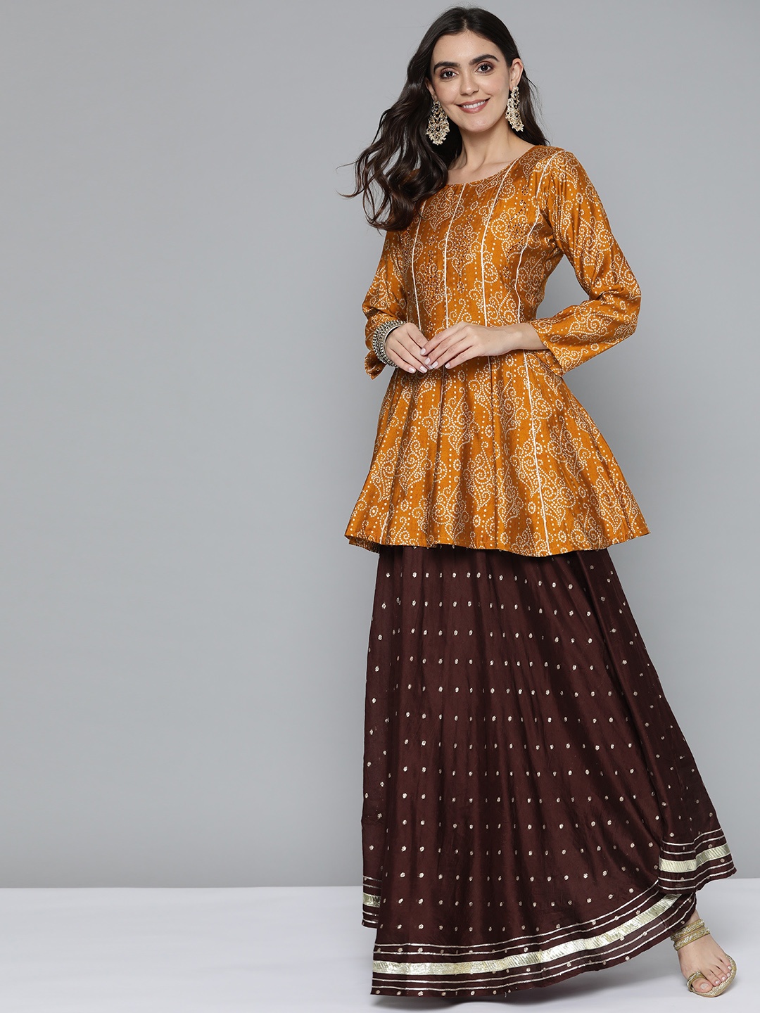 

Kvsfab Women Mustard Brown & White Bandhani Panelled Sequinned Kurta with Skirt