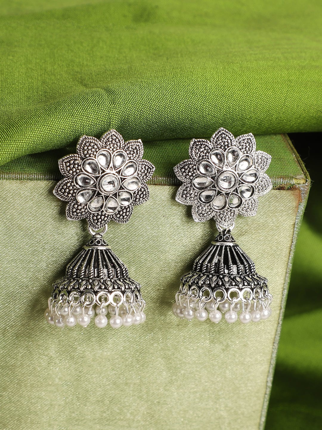 ANIKAS CREATION Silver-Plated Contemporary Jhumkas Earrings