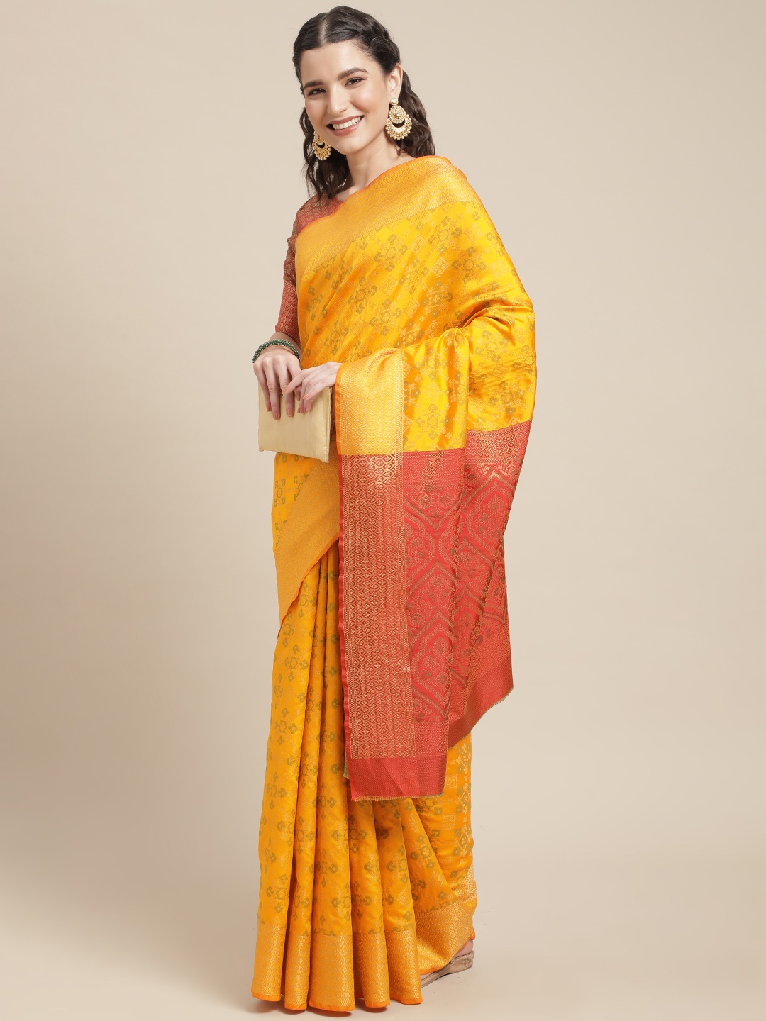 

Mitera Mustard Yellow & Orange Ethnic Motifs Zari Silk Blend Patola Saree