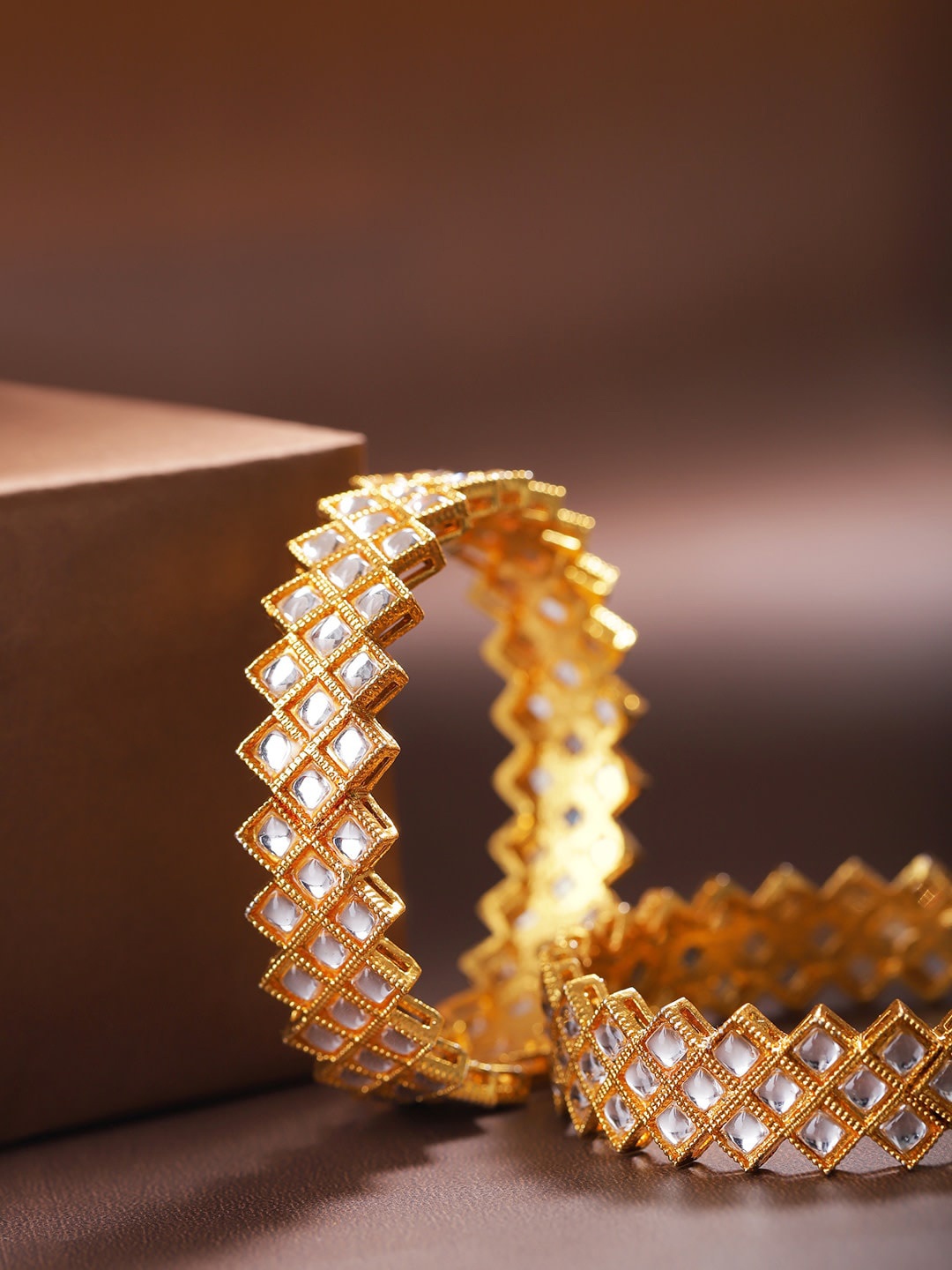 

Priyaasi Women Gold-Plated White Kundan-Studded Patterned Bangles