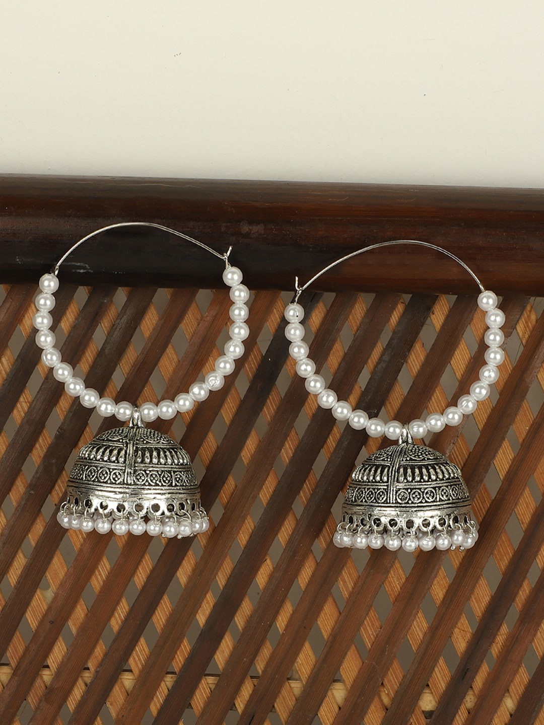 

ANIKAS CREATION Silver-Toned Contemporary Jhumkas Earrings