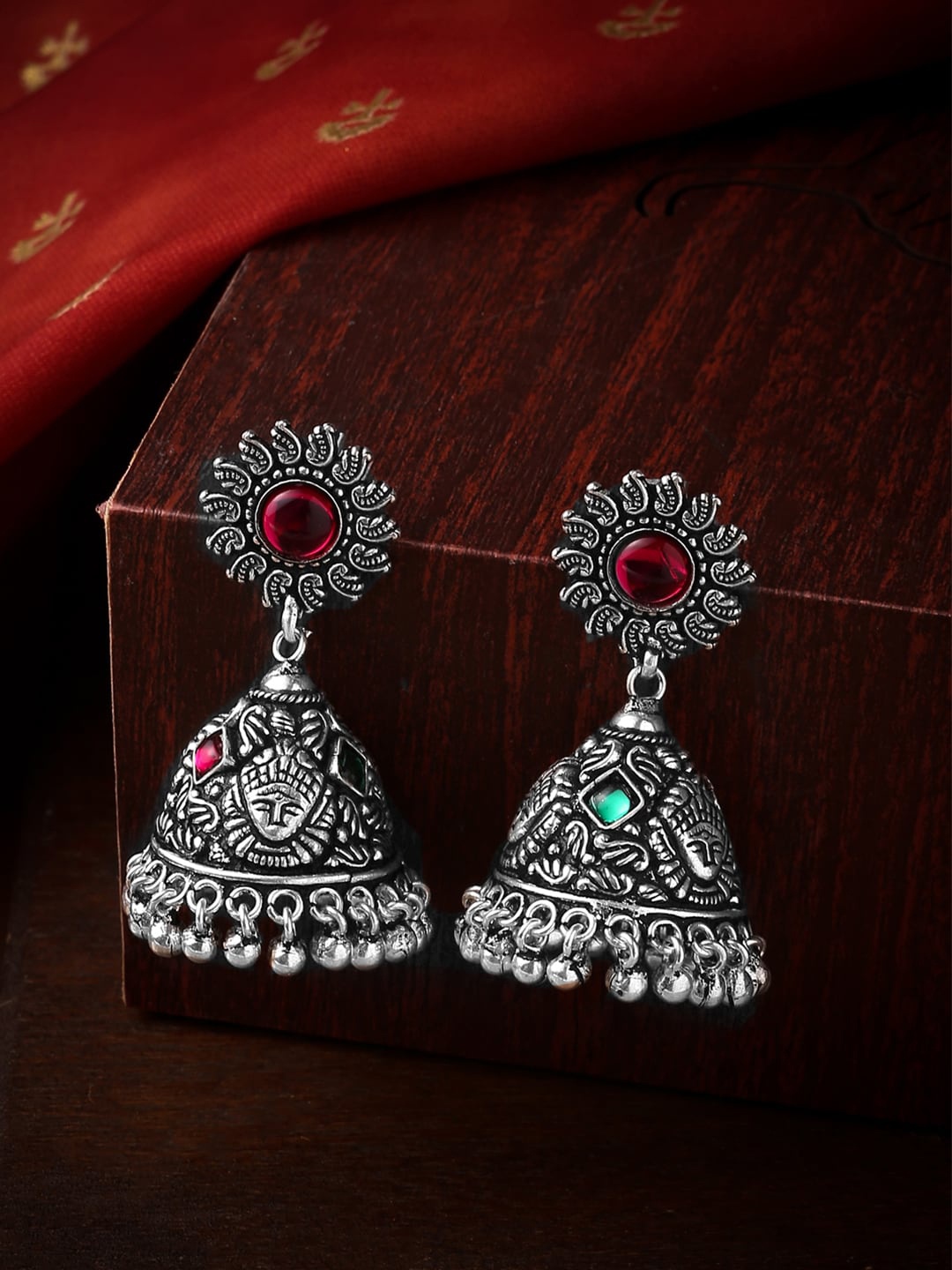 

Yellow Chimes Silver-Toned & Red Stone Studded Dome Shaped Jhumkas Earrings