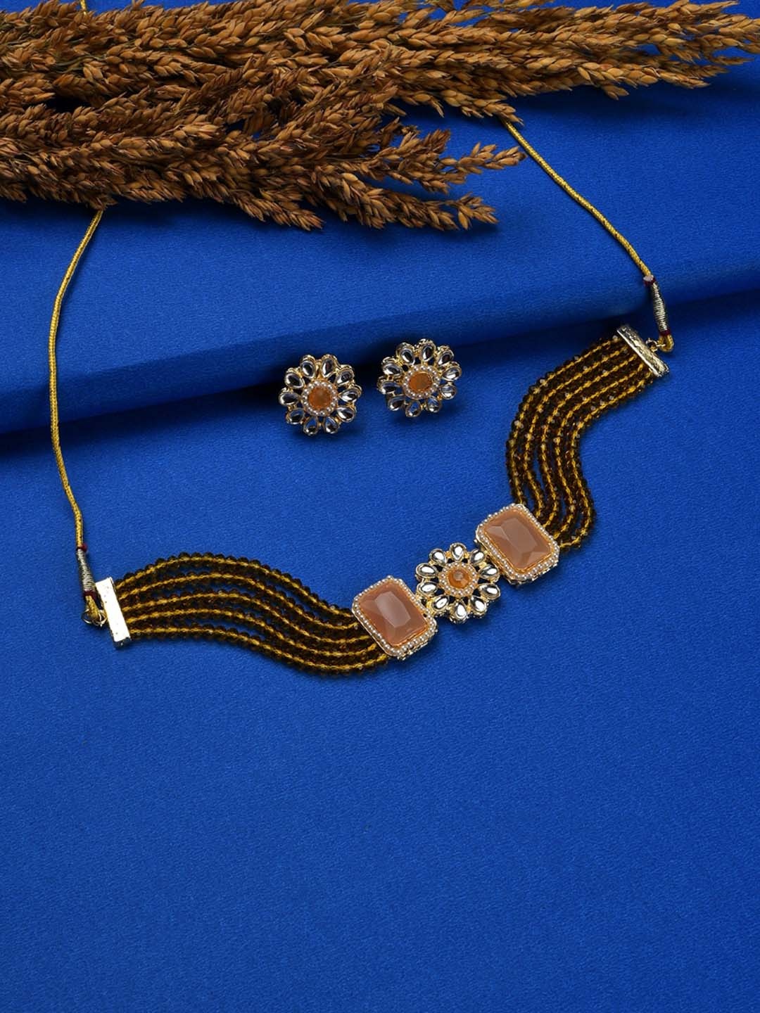 

SOHI Gold-Plated Orange & White Stone-Studded & Beaded Jewellery Set