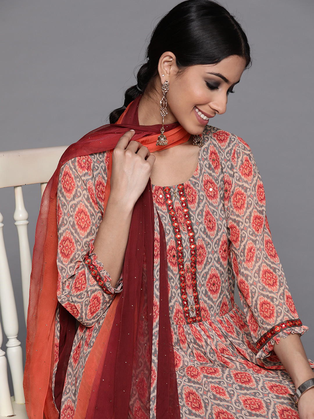 

Libas Women Orange Floral Printed Panelled Mirror Work Kurta with Sharara & With Dupatta