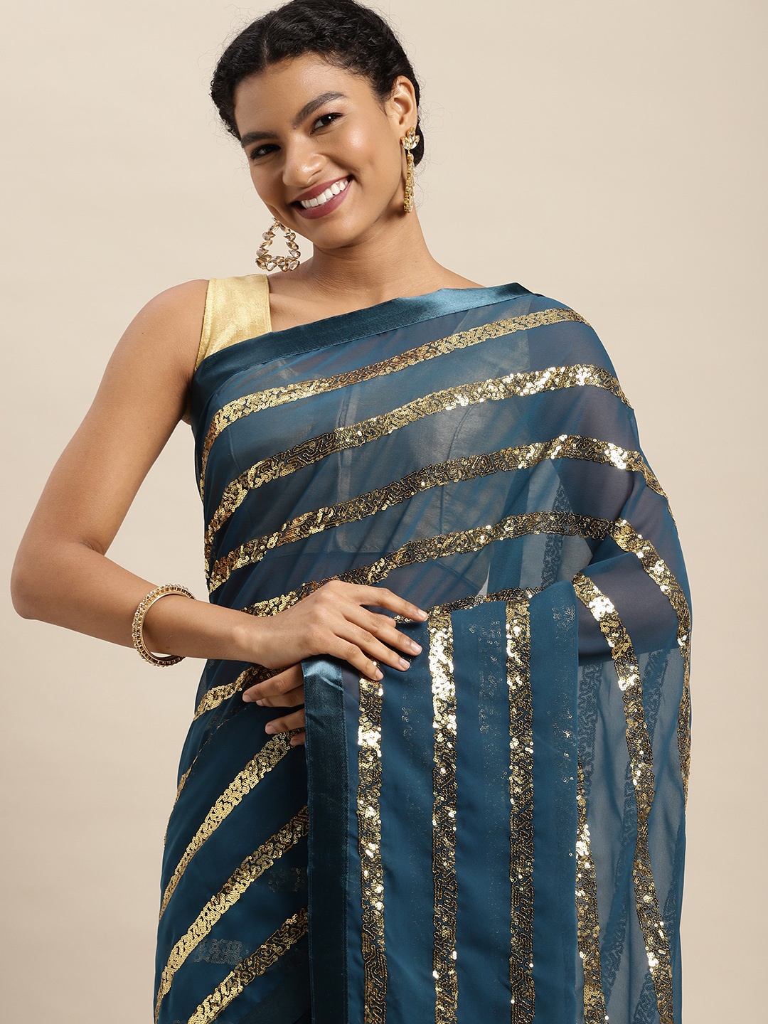 

Mitera Teal Blue & Golden Embellished Saree