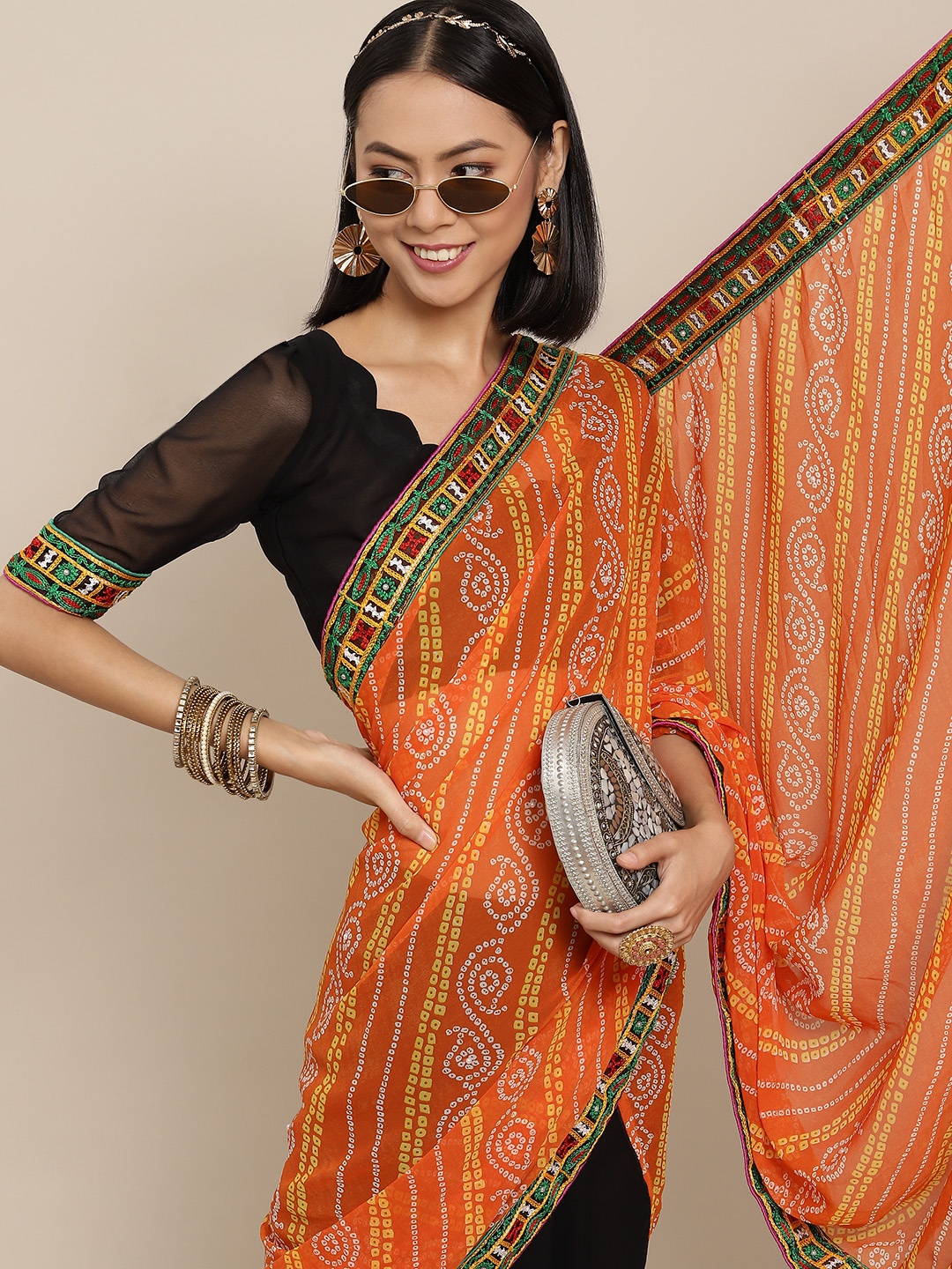 

Mitera Orange & Black Ethnic Motifs Kutchi Embroidery Pure Georgette Saree