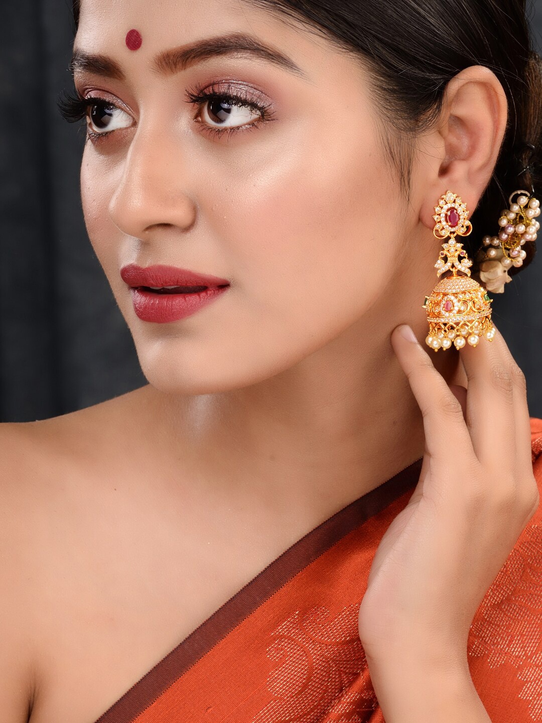 

Saraf RS Jewellery Gold-Plated & Pink AD Stone Contemporary Jhumkas Earrings