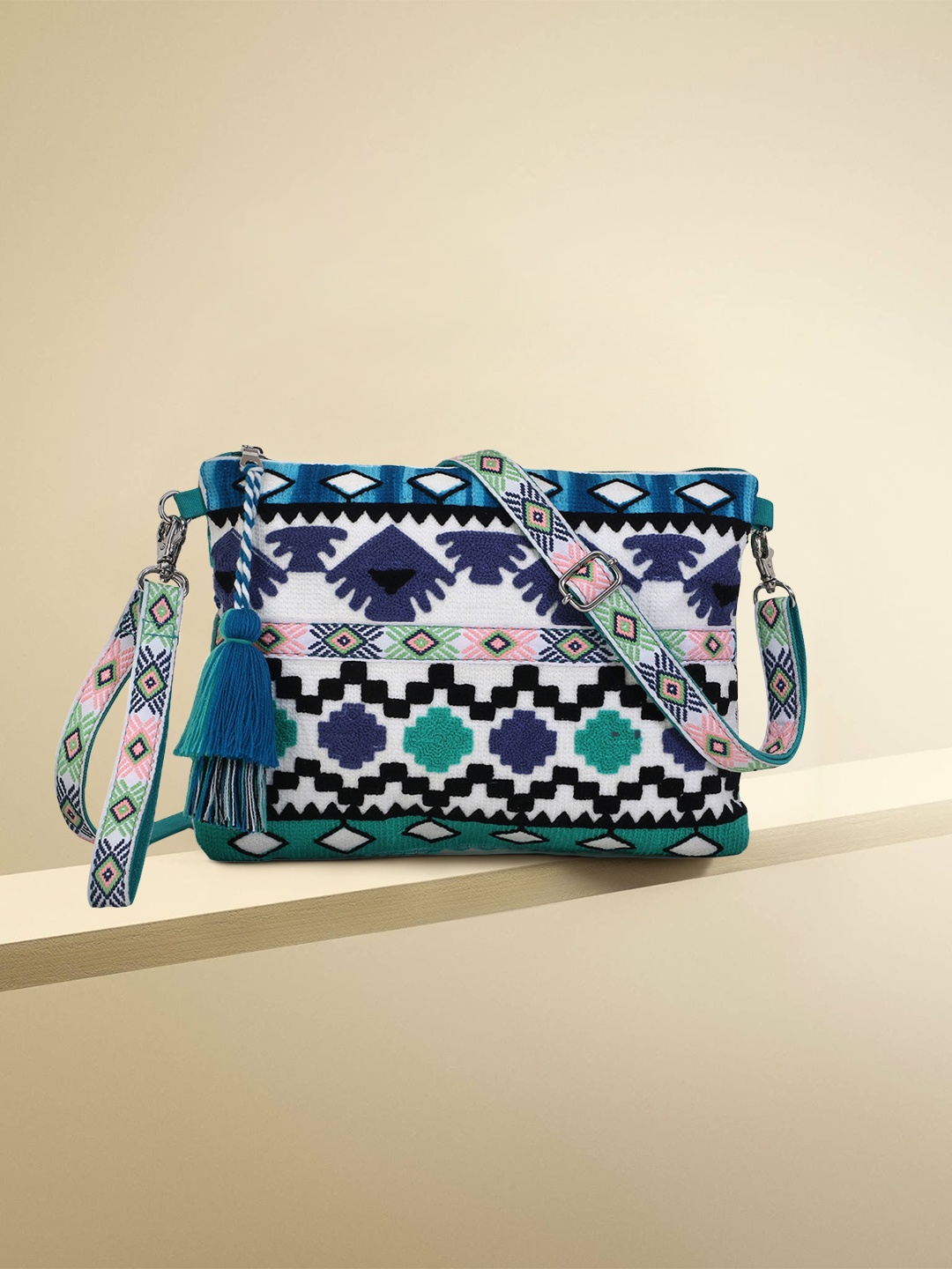 

Anekaant Turquoise Blue Ethnic Motifs Embellished Structured Sling Bag with Tasselled