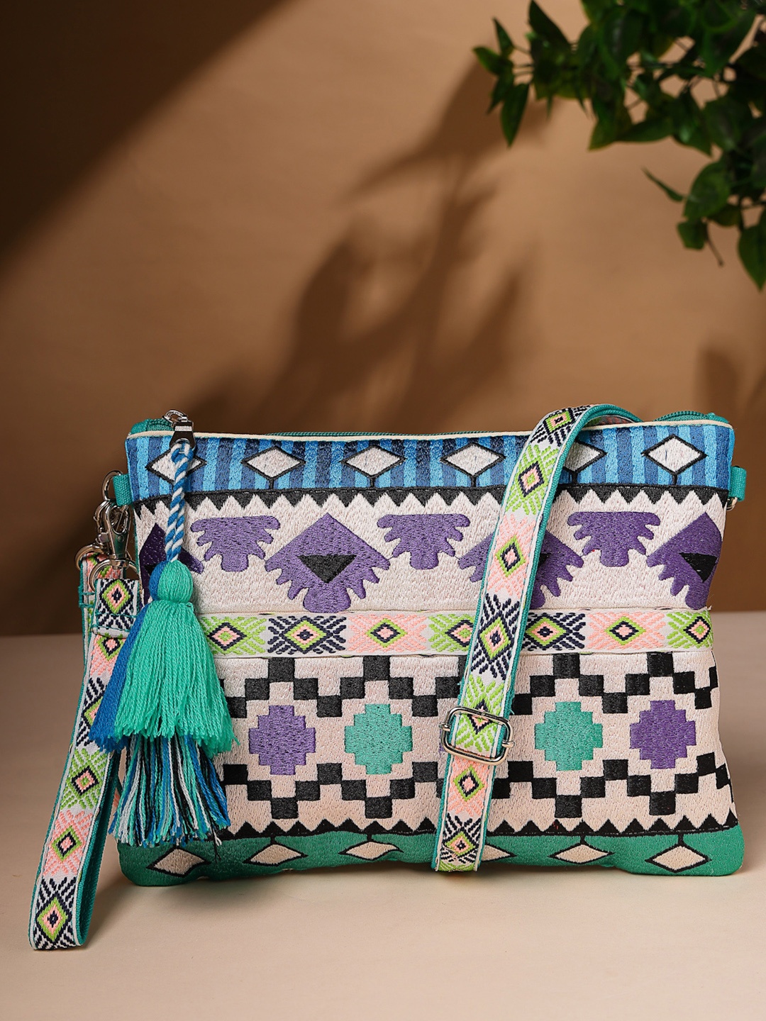 

Anekaant Turquoise Blue Ethnic Motifs Embellished Structured Sling Bag with Tasselled