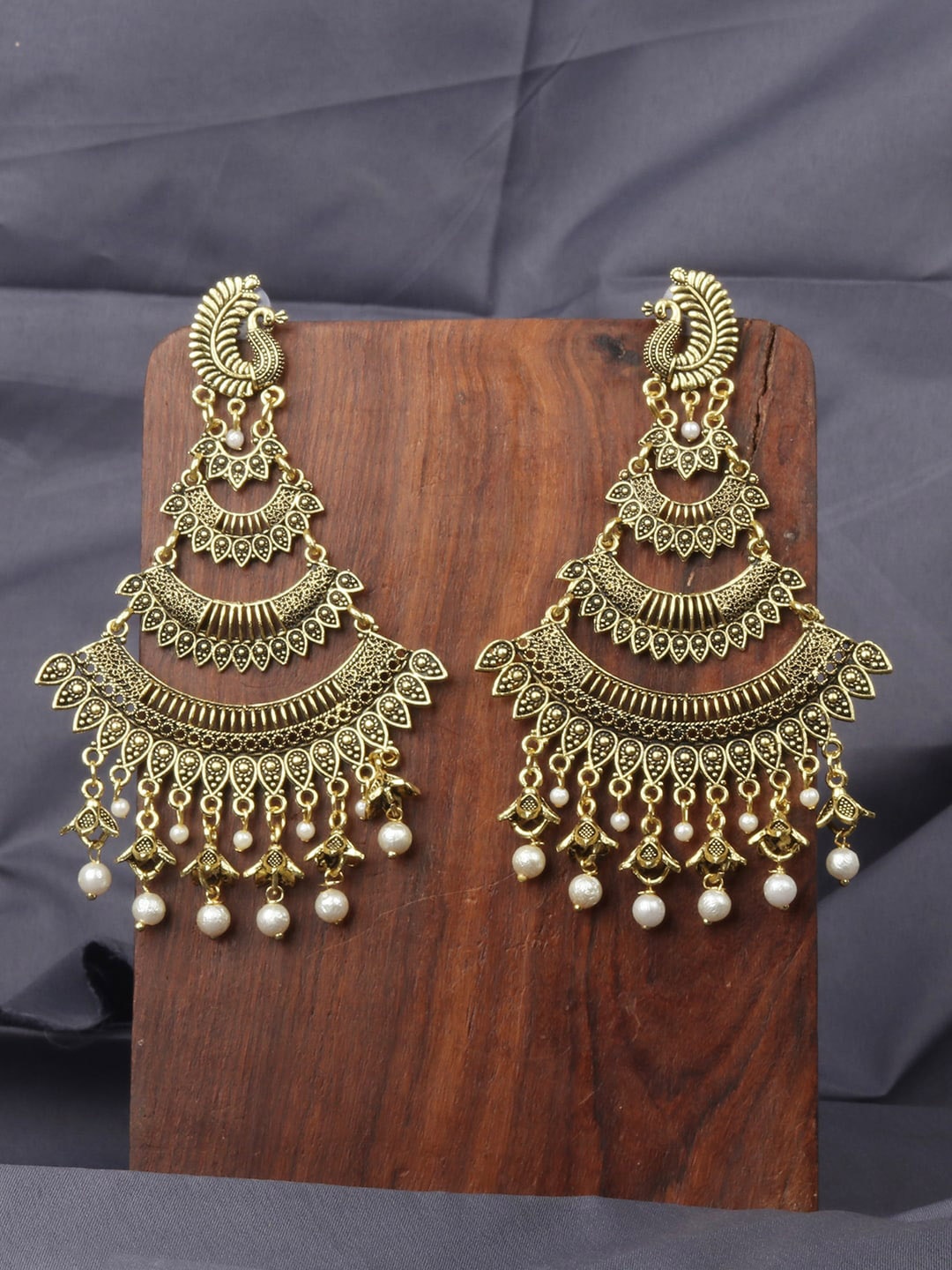 

ANIKAS CREATION Gold-Toned & White Peacock Shaped Chandbalis Earrings