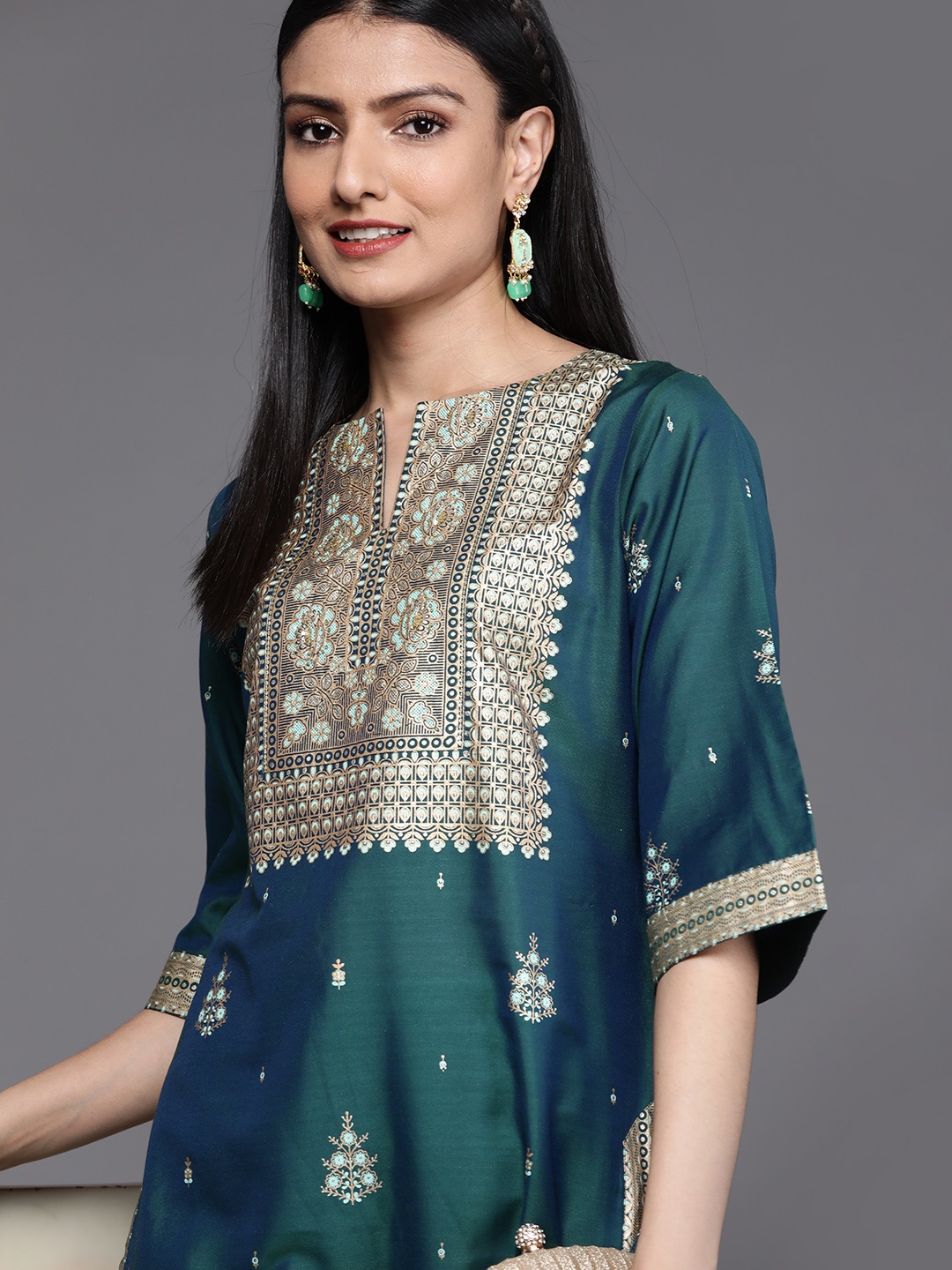 

Libas Women Teal Green & Golden Ethnic Motifs Yoke Design Flared Sleeves Kurta