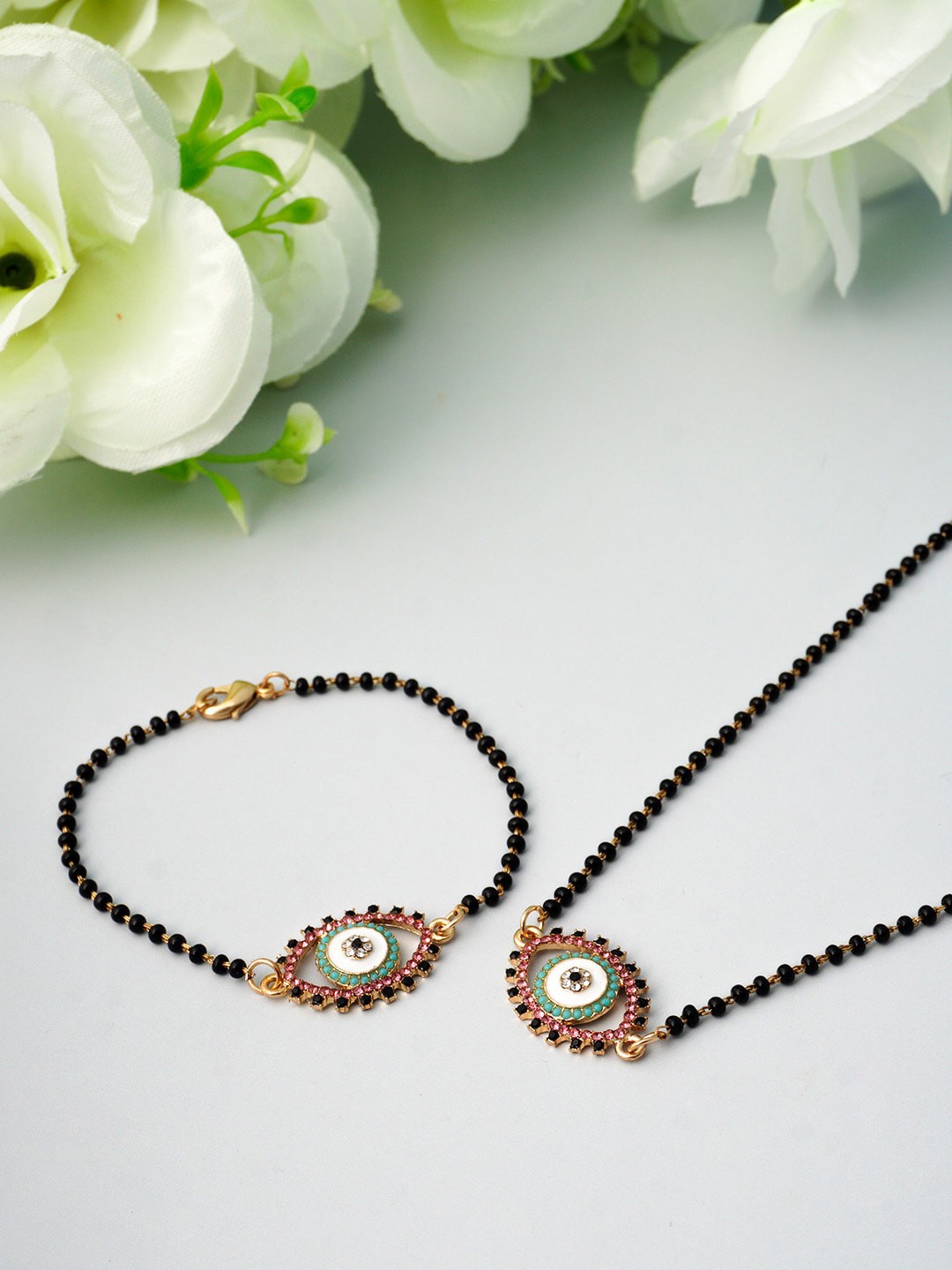 

Ferosh Gold-Colored Black Stone Beaded Evil Eye Mangalsutra Jewellery Set