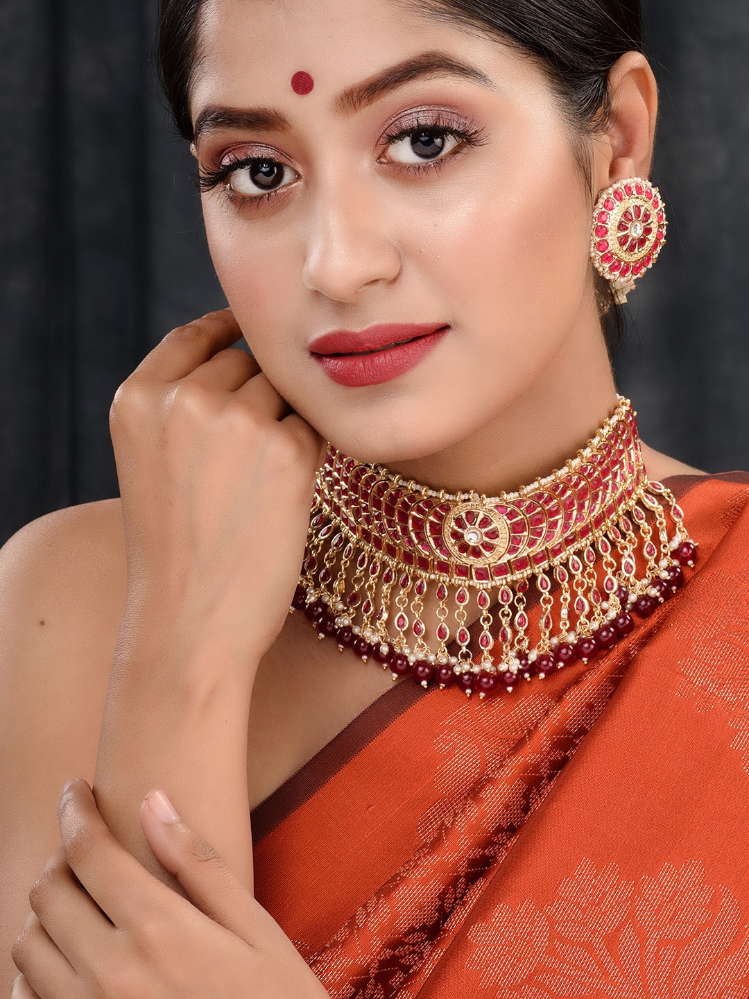 

Saraf RS Jewellery Gold Plated Red Stone Studded Pearl Beaded Choker Jewellery Set