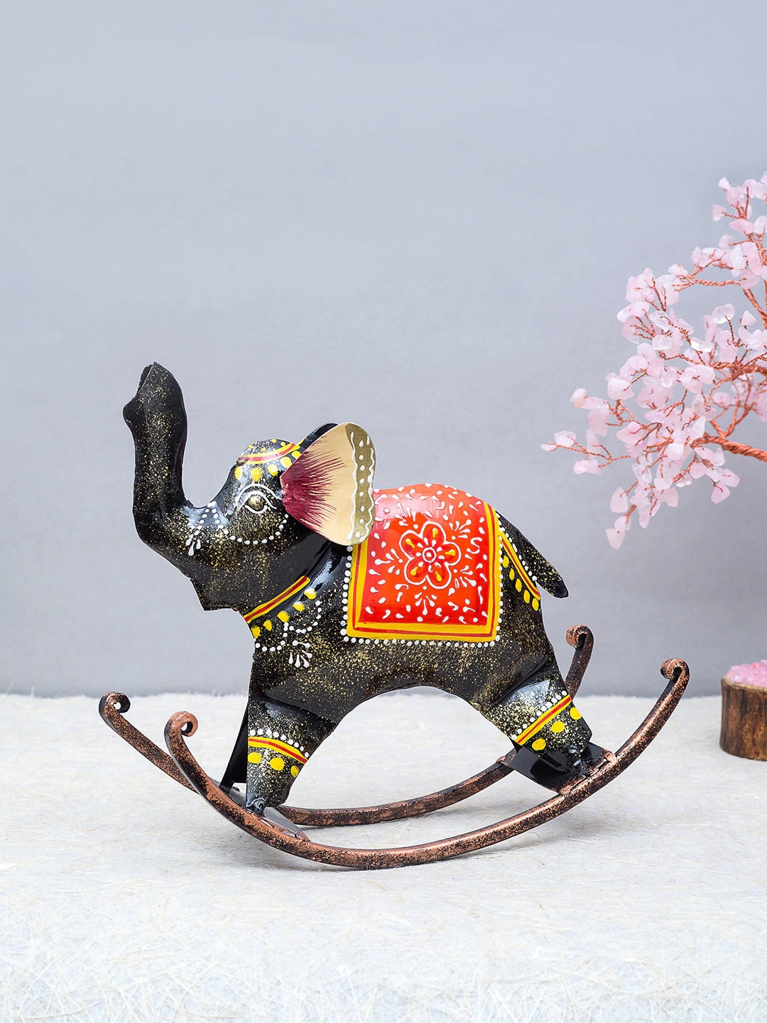 

Golden Peacock Brown & Orange Metal Rocking Elephant Showpiece