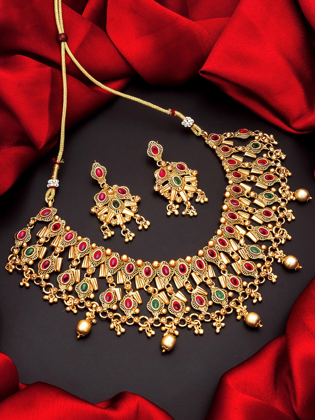 

aadita Gold Plated & Green Temple Studded Jewellery Set