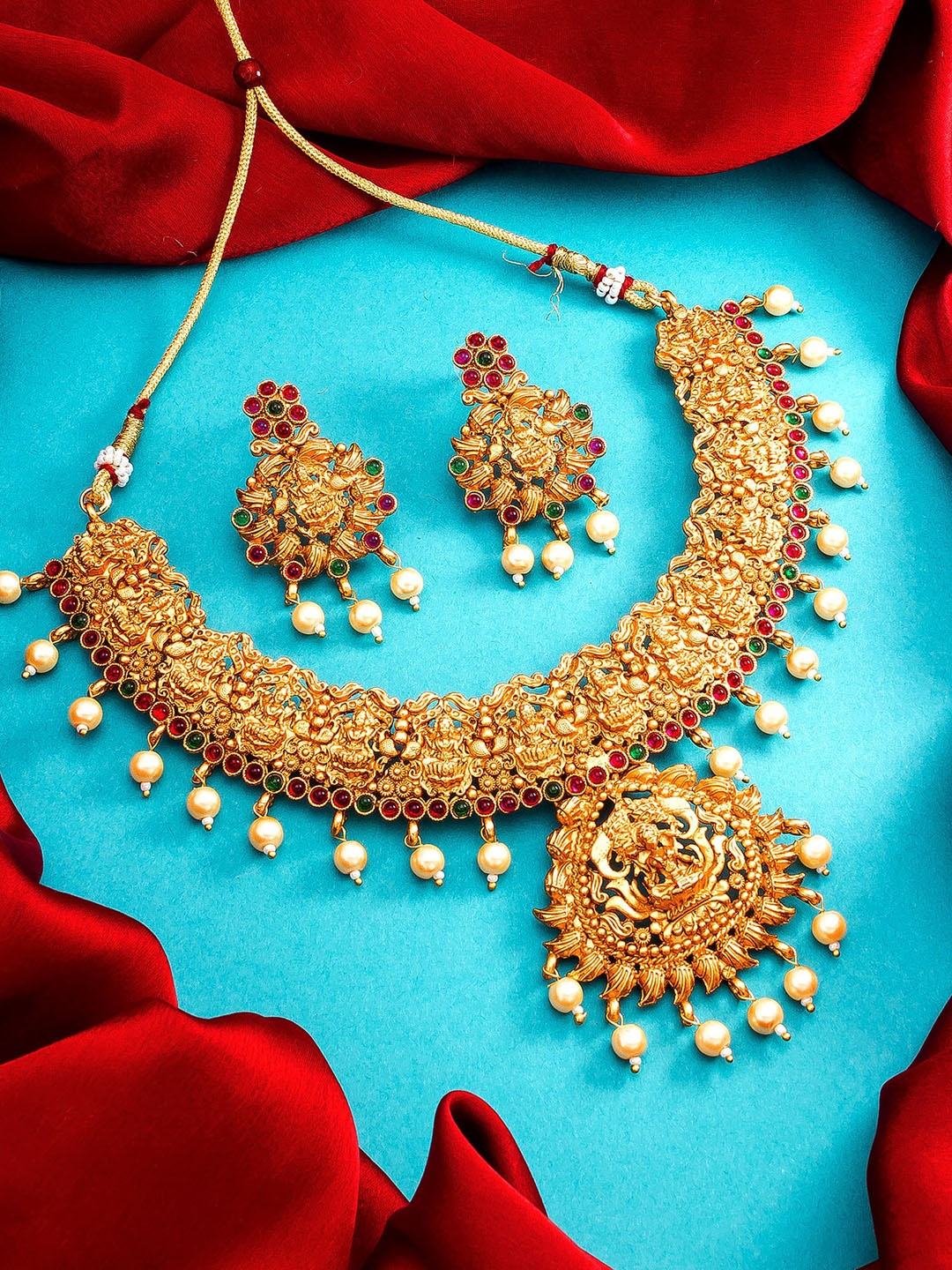 

aadita Gold Plated & Green Temple Studded Jewellery Set