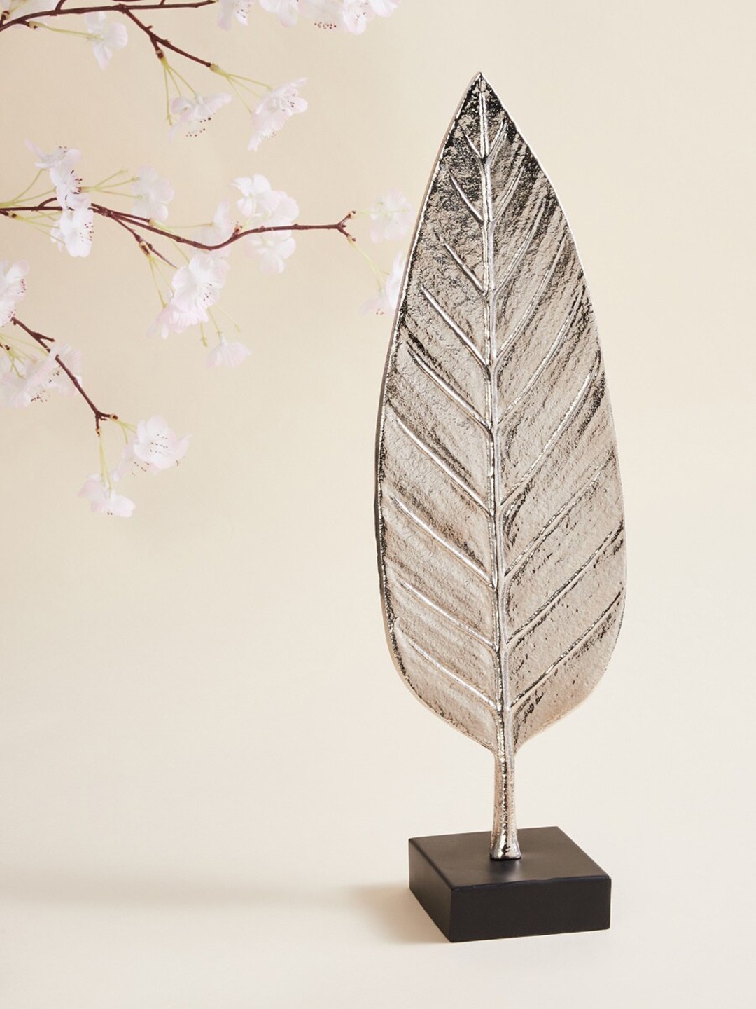 

Home Centre Silver-Toned & Black Textured Metal Leaf Sculpture Showpieces