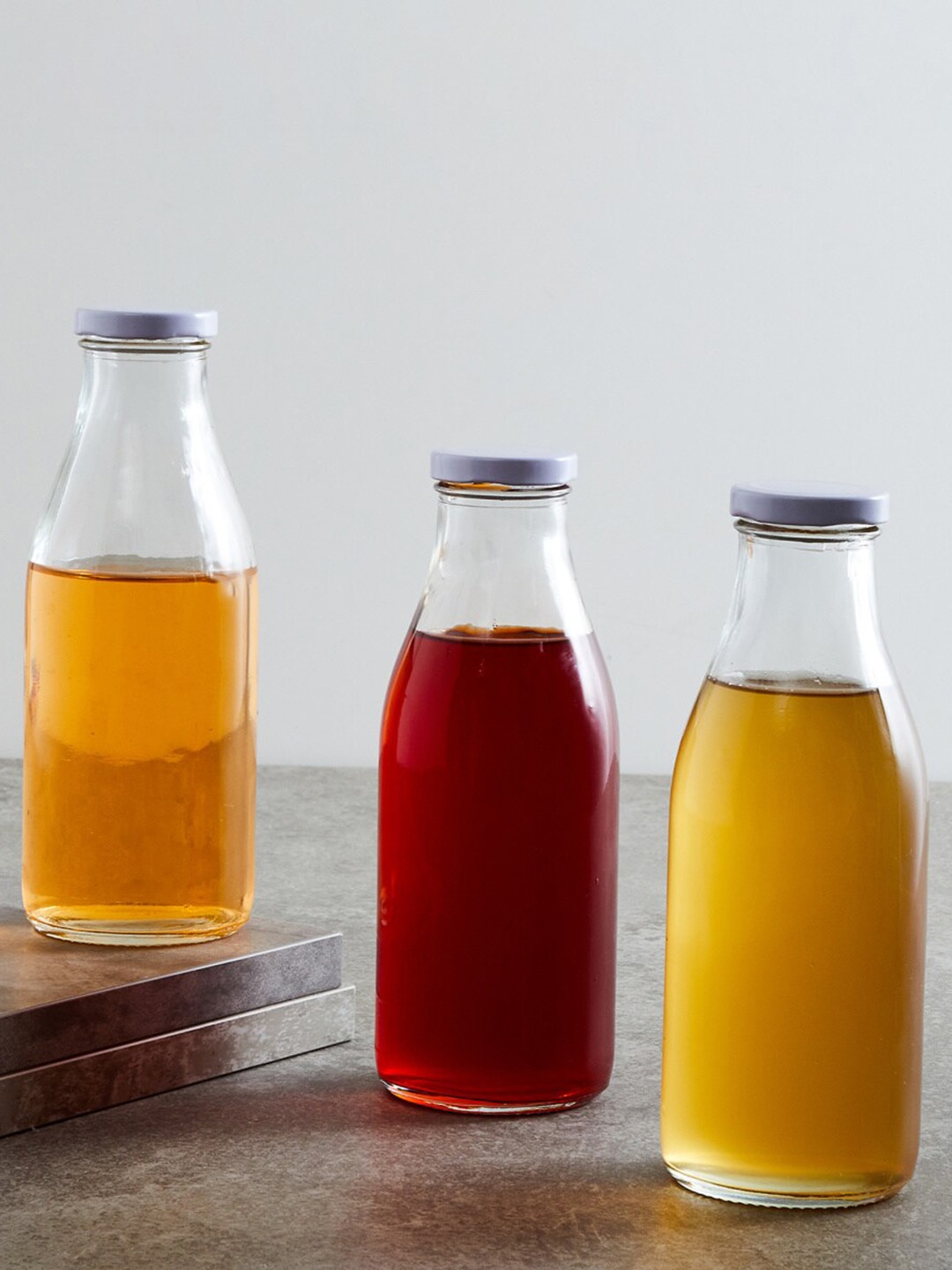 

Home Centre Set Of 3 Transparent Solid Glass Bottles