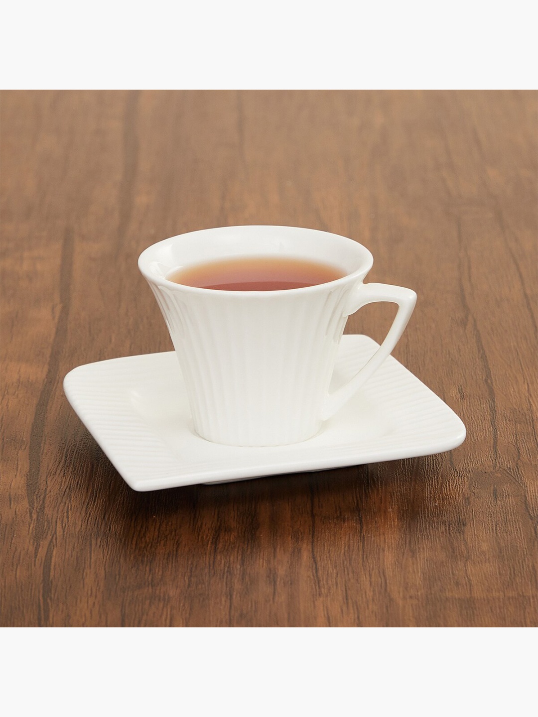 

Home Centre White Textured Ceramic Glossy Cup and Saucer Set