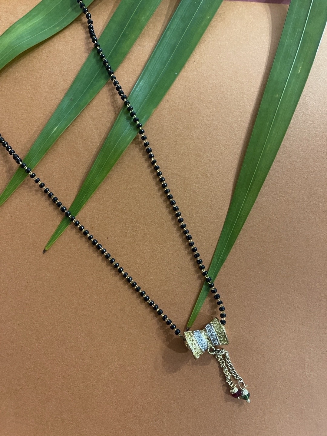 

Digital Dress Room Gold-Plated Black Stone-Studded & Beaded Mangalsutra