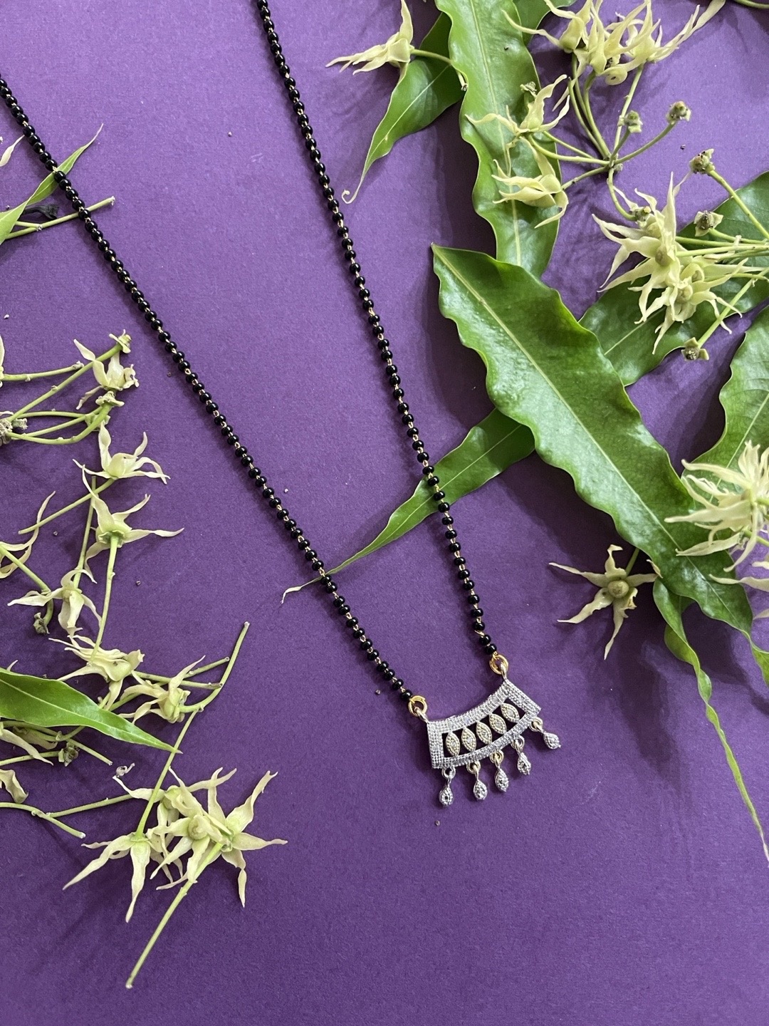 

Digital Dress Room Gold-Plated White Stone-Studded & Black Beaded Mangalsutra