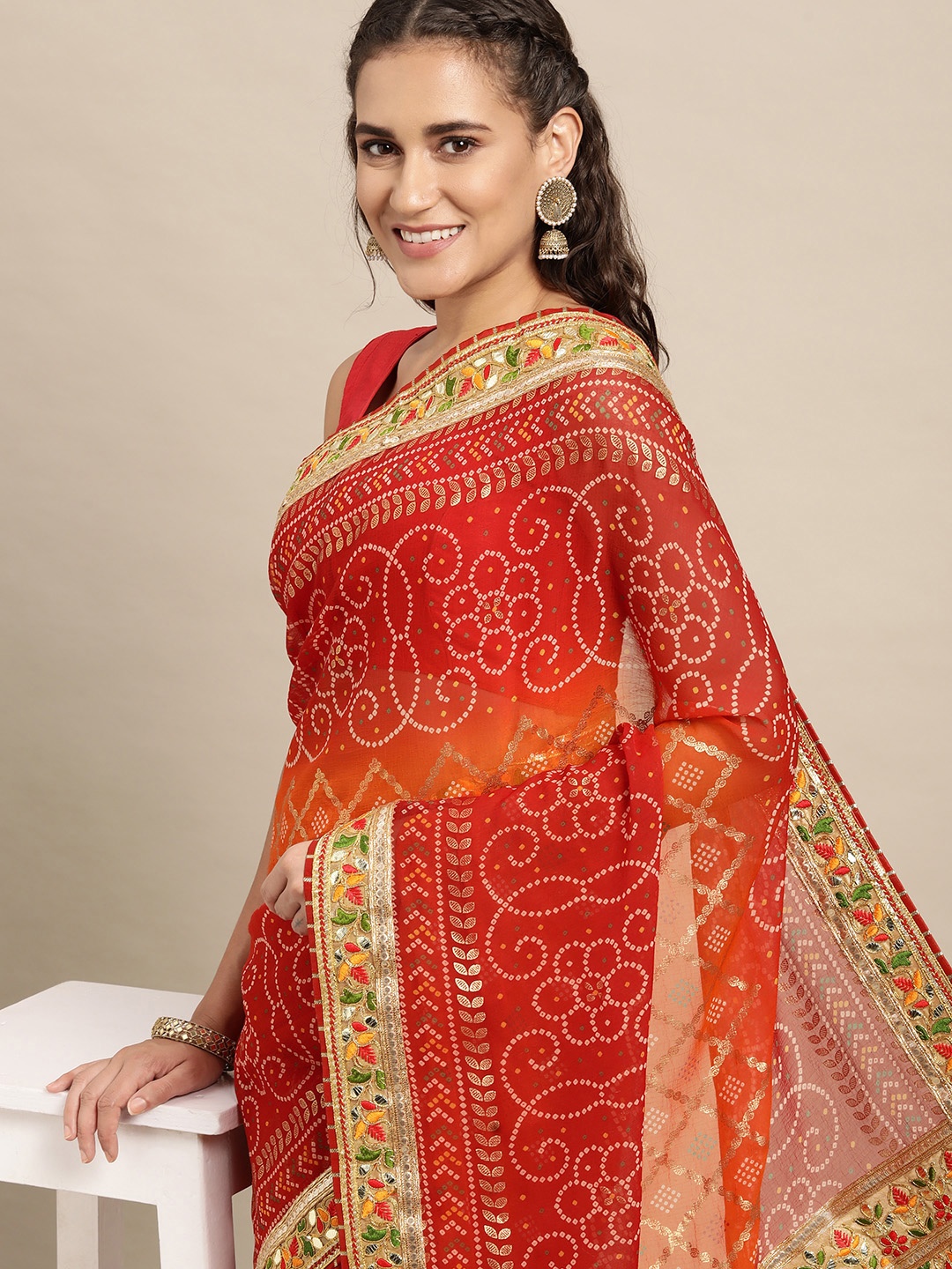 

VASTRANAND Maroon & Orange Sequinned Bandhani Saree