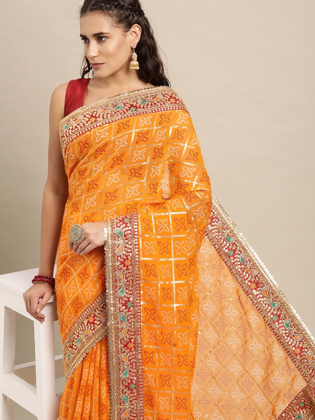 

VASTRANAND Yellow & Red Sequinned Bandhani Saree