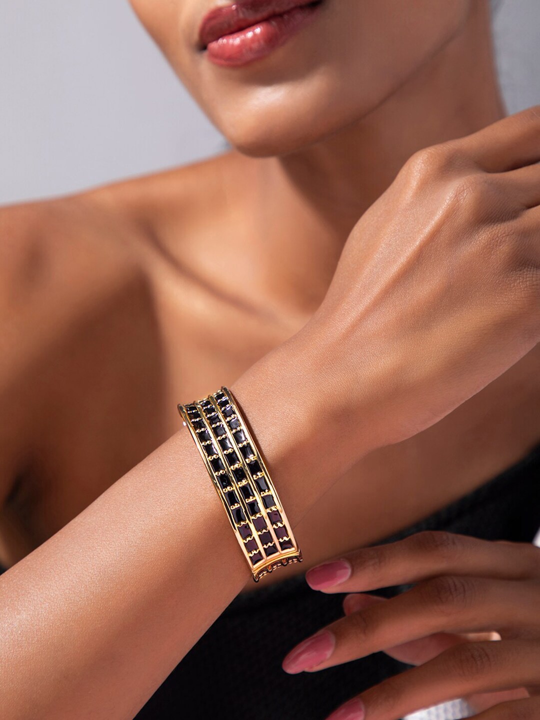 

Rubans Voguish Women Gold-Plated & Black Bangle-Style Bracelet