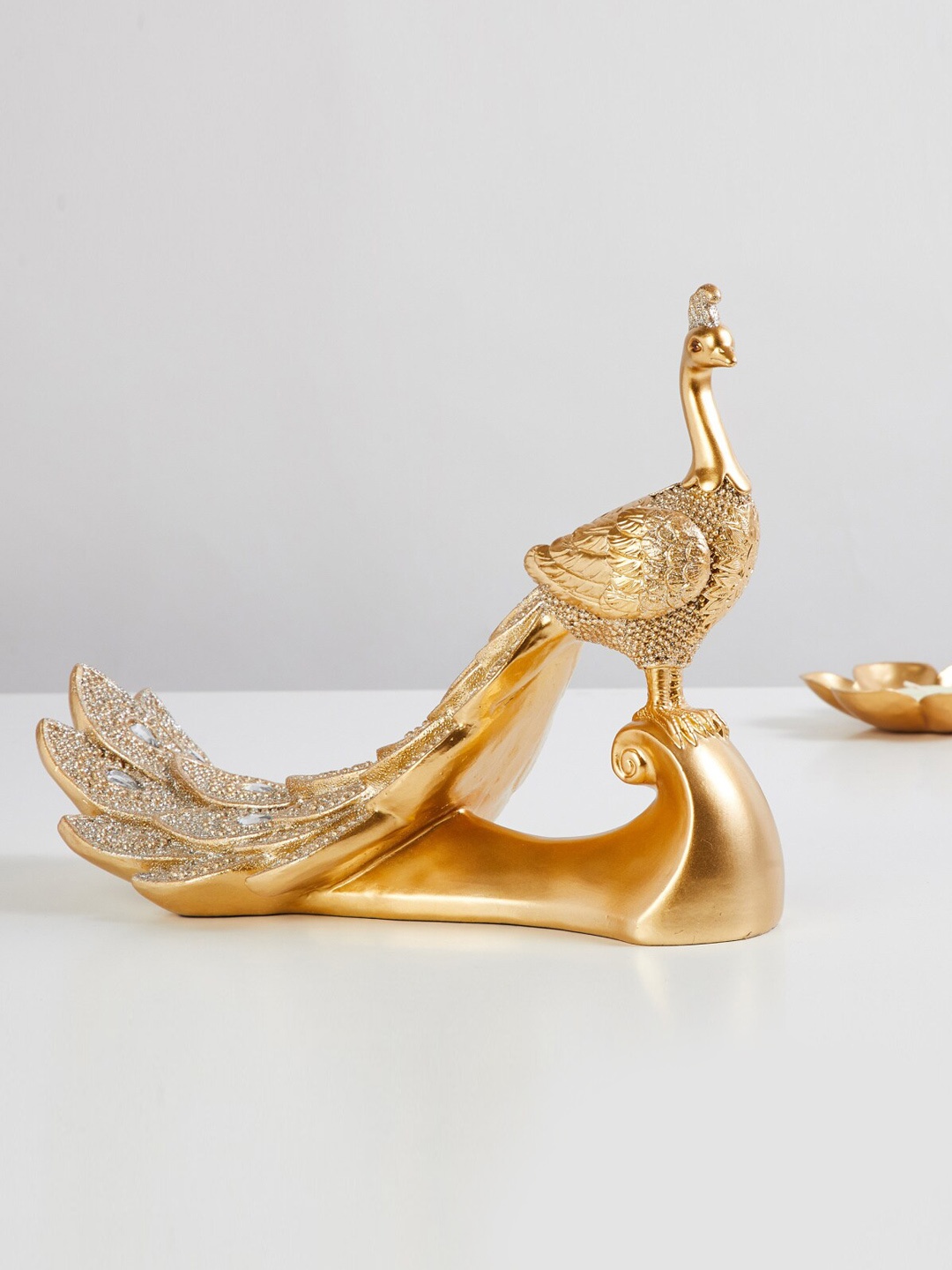 

Home Centre Gold-Toned Textured Peacock Figurine Showpieces