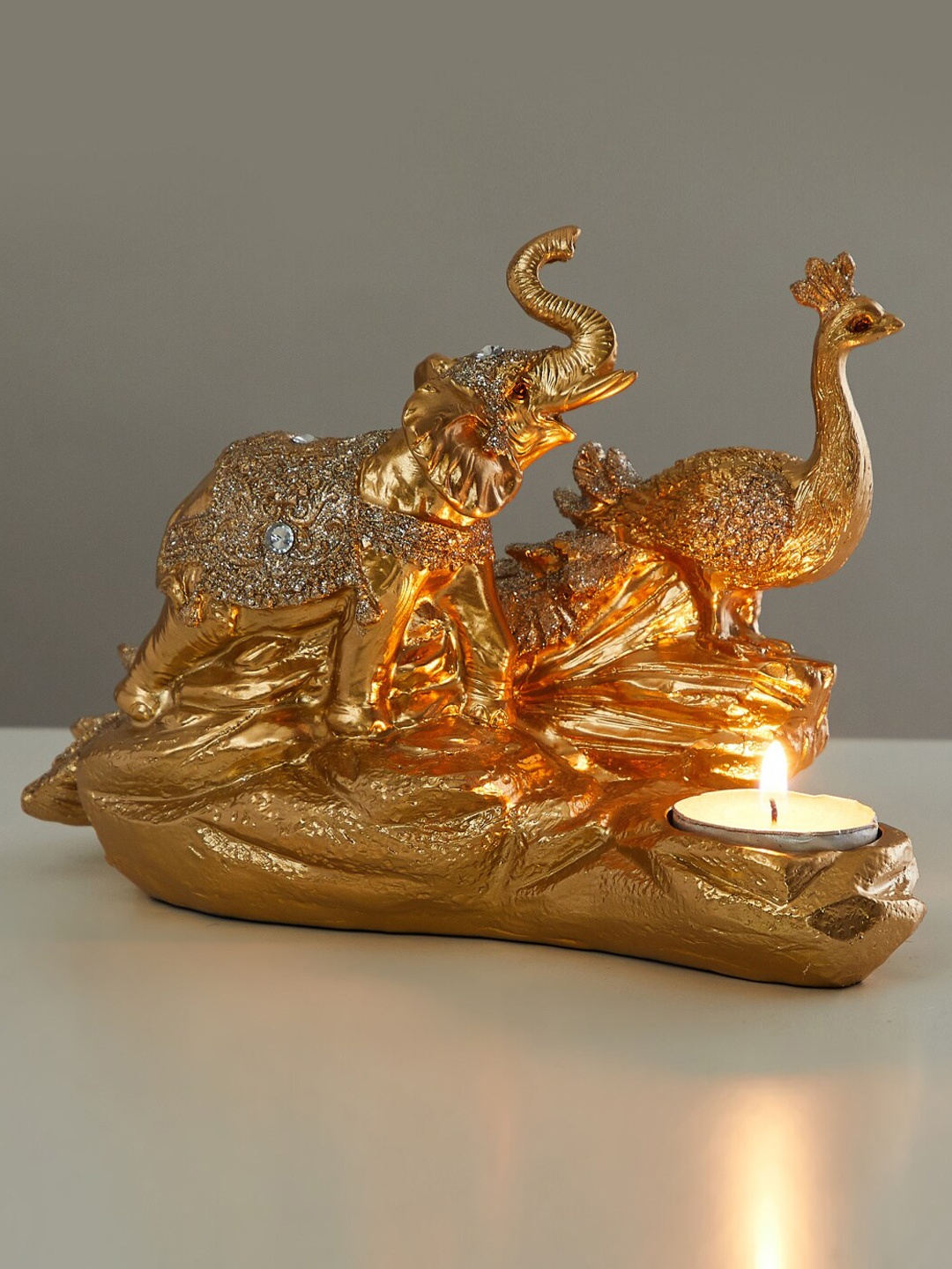 

Home Centre Gold-Toned Corsica Textured Metal Peacock with Elephant Candle Holder