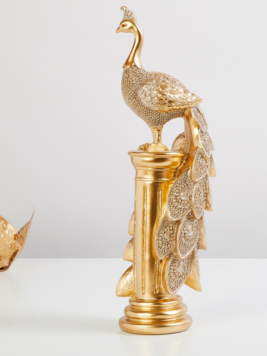 

Home Centre Gold-Toned Textured Peacock Figurine Showpieces