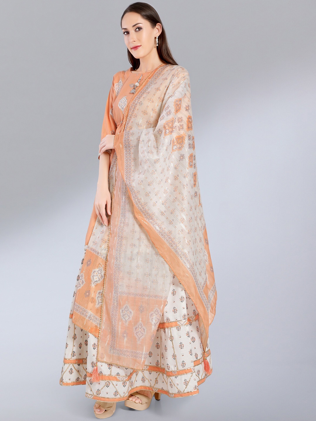 

MADHURAM Women Peach-Coloured Ethnic Motifs Printed Kurta with Skirt & With Dupatta