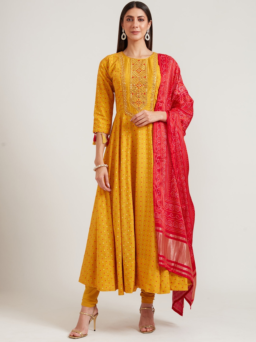 

Neerus Women Mustard Yellow Layered Mirror Work Kurta with Churidar & With Dupatta