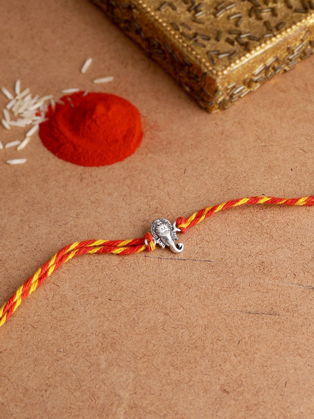

ADORN by Nikita Ladiwala Silver-Toned 92.5 Sterling Silver Rakhi With Roli Chawal