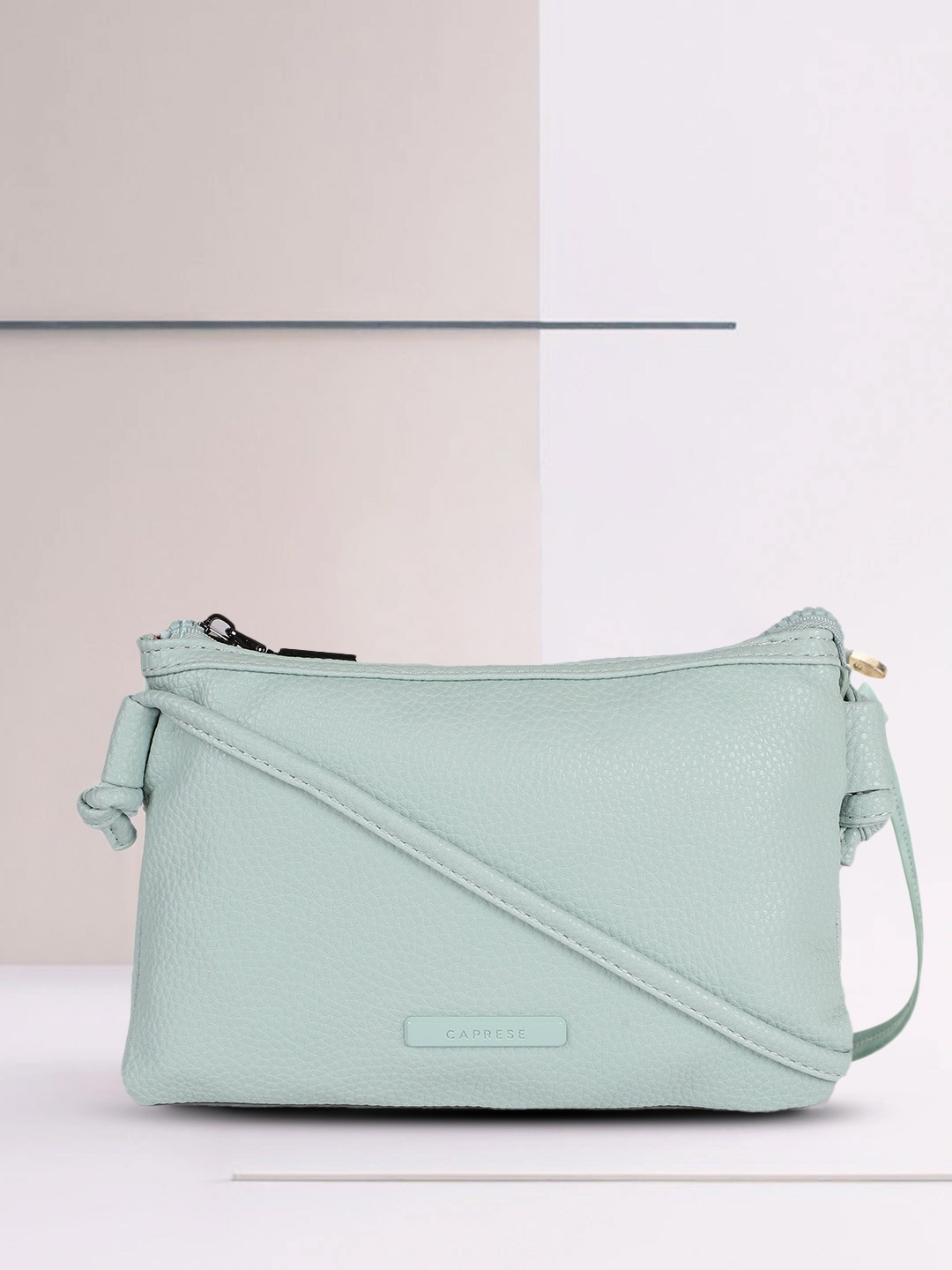 

Caprese Women Blue Solid Structured Sling Bag